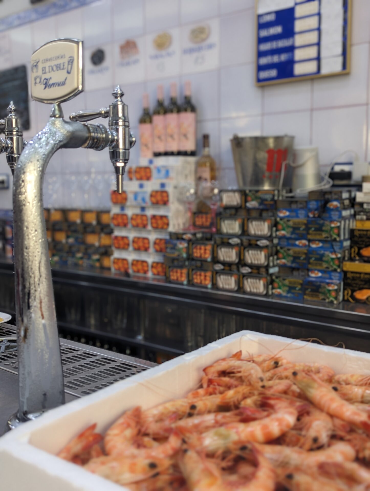 a tap with a tray of shrimp in front of a counter