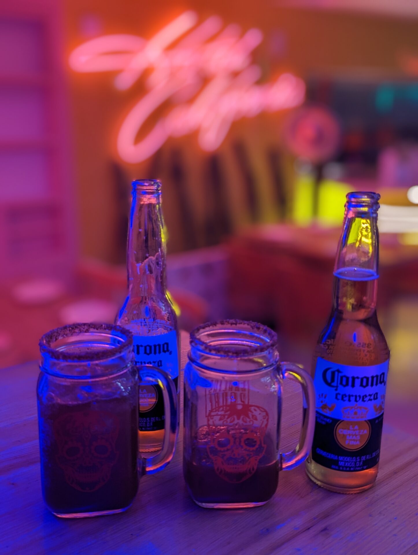 a group of beer bottles and mugs on a table