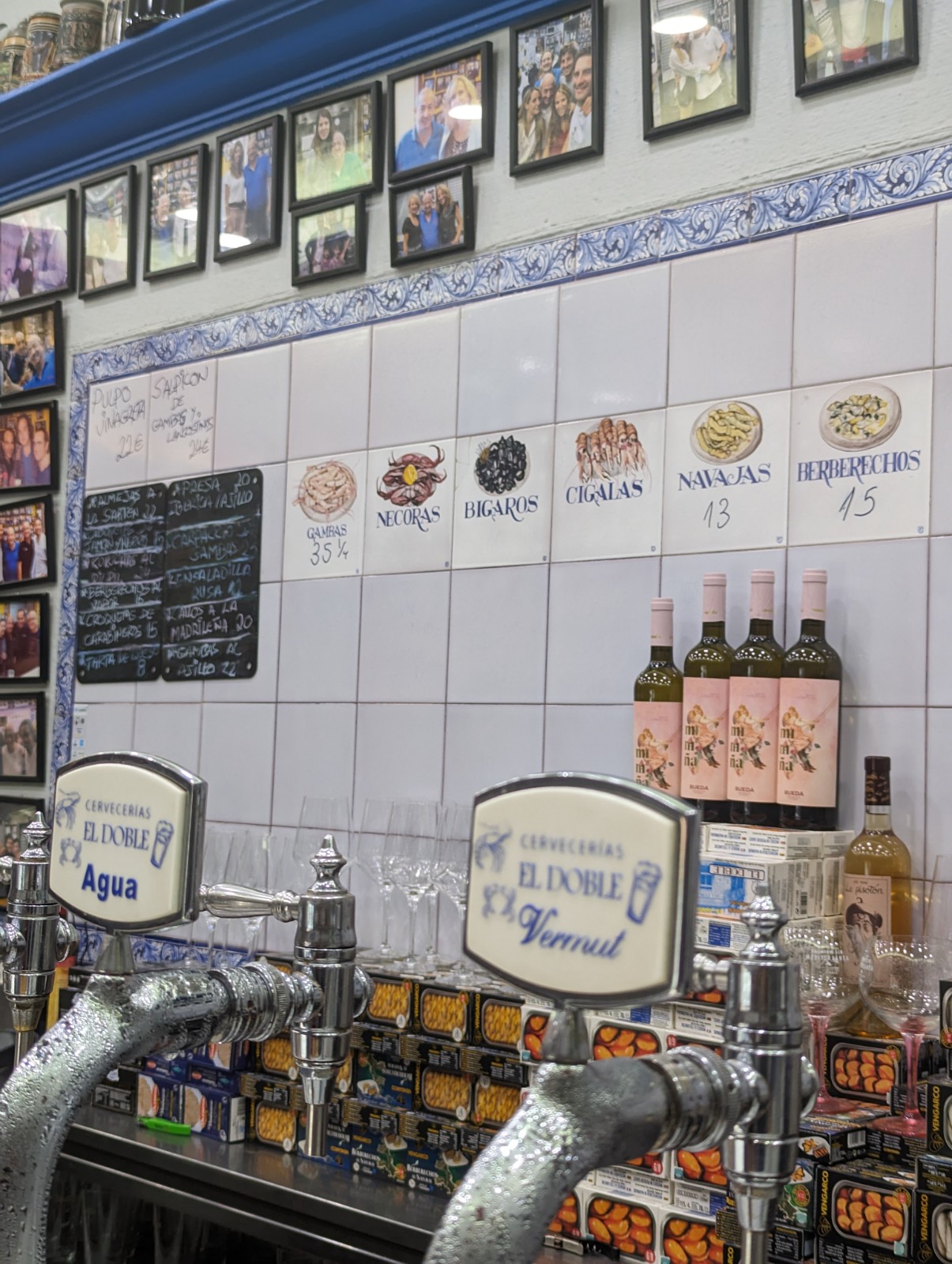 a row of beer taps and bottles on a wall