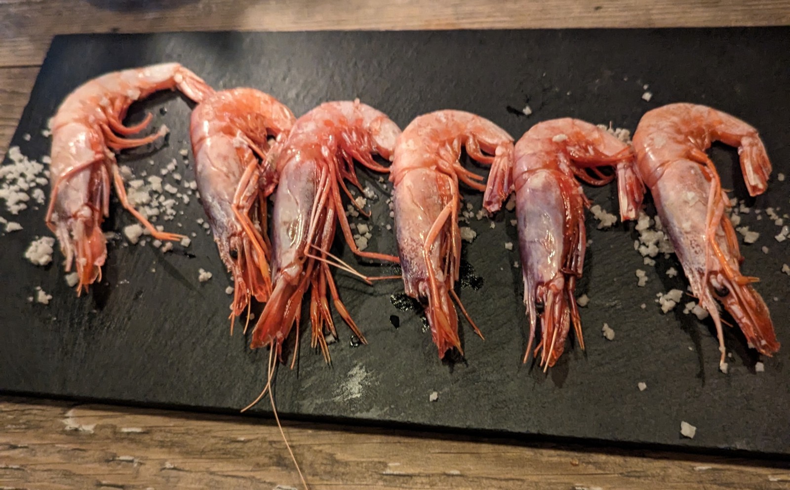 a group of shrimp on a black board