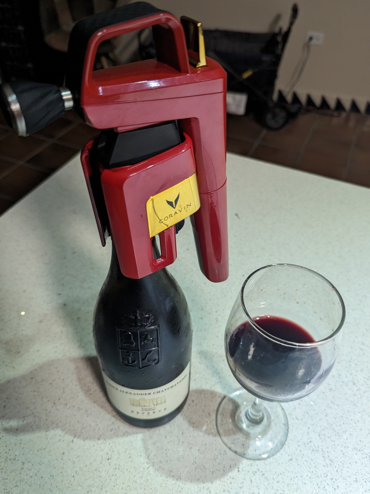a red wine bottle and glass on a table