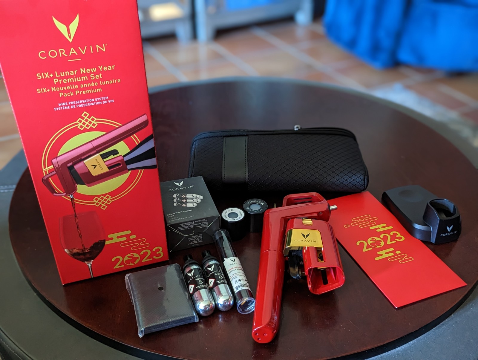 a table with a red box and a red lighter and a red package