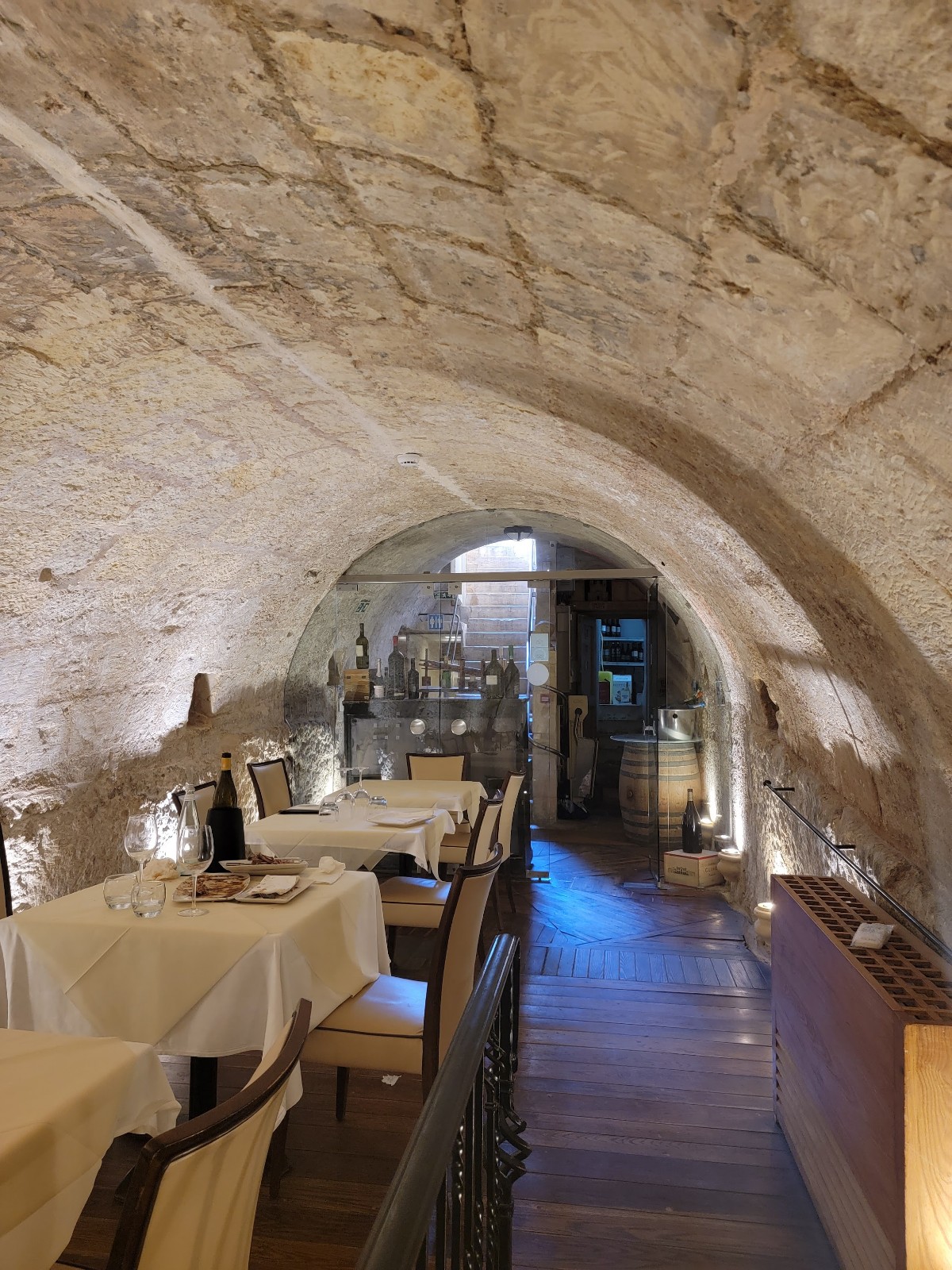 a restaurant with tables and chairs in a stone tunnel
