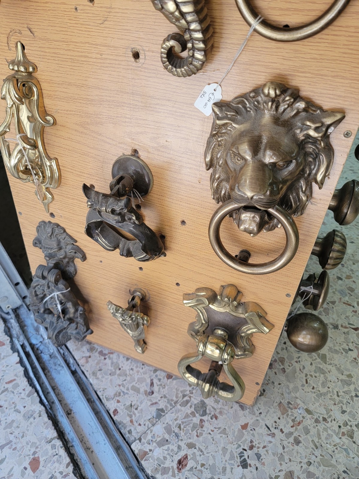 a group of brass knockers on a wood surface