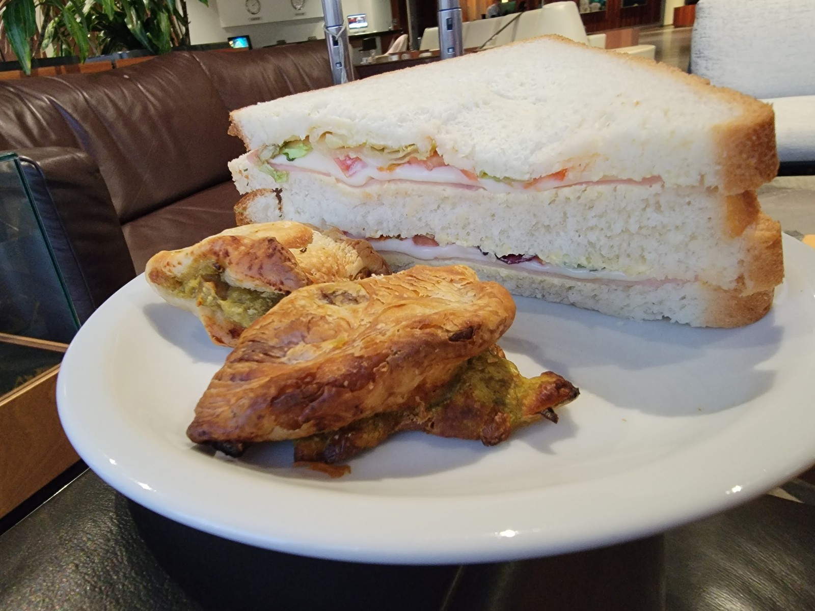 a sandwich and pastries on a plate