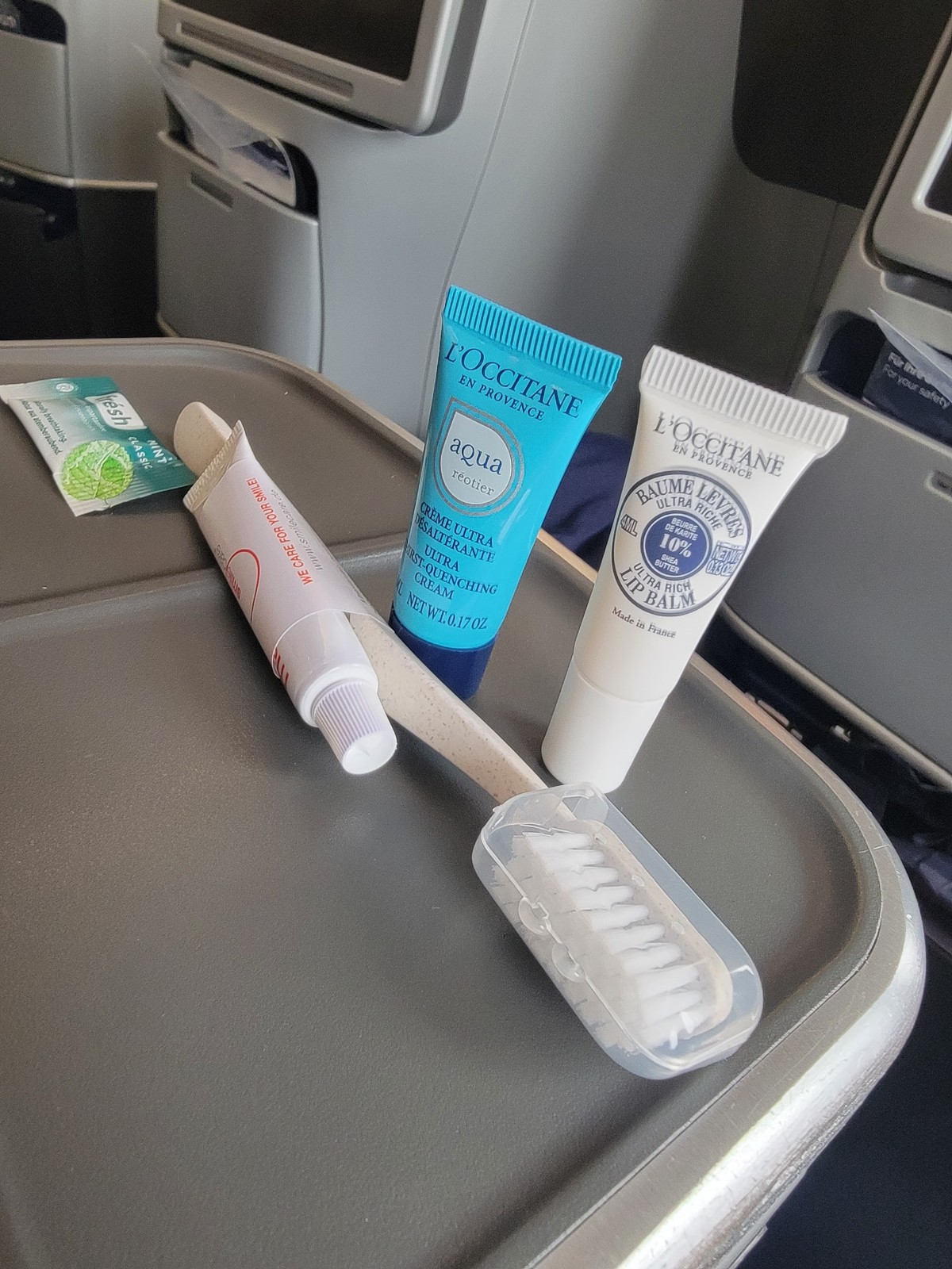 a group of toothpaste and toothbrush on a tray