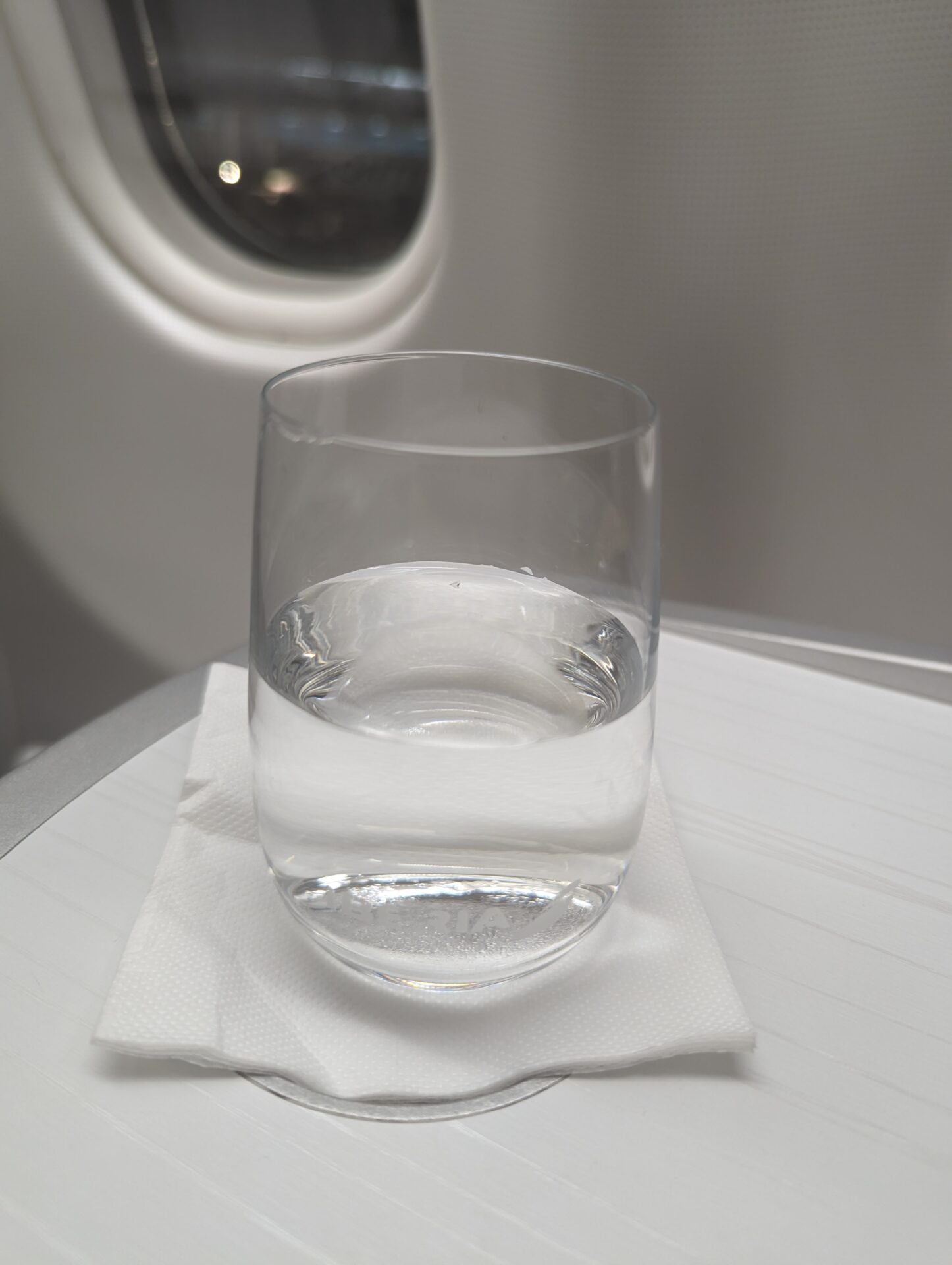 a glass of water on a napkin
