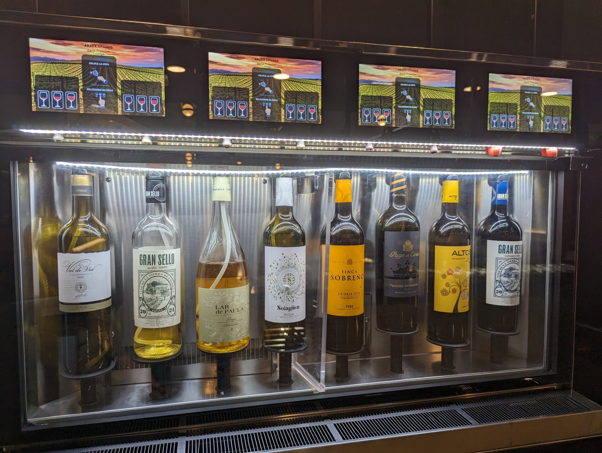 a display case with bottles of wine