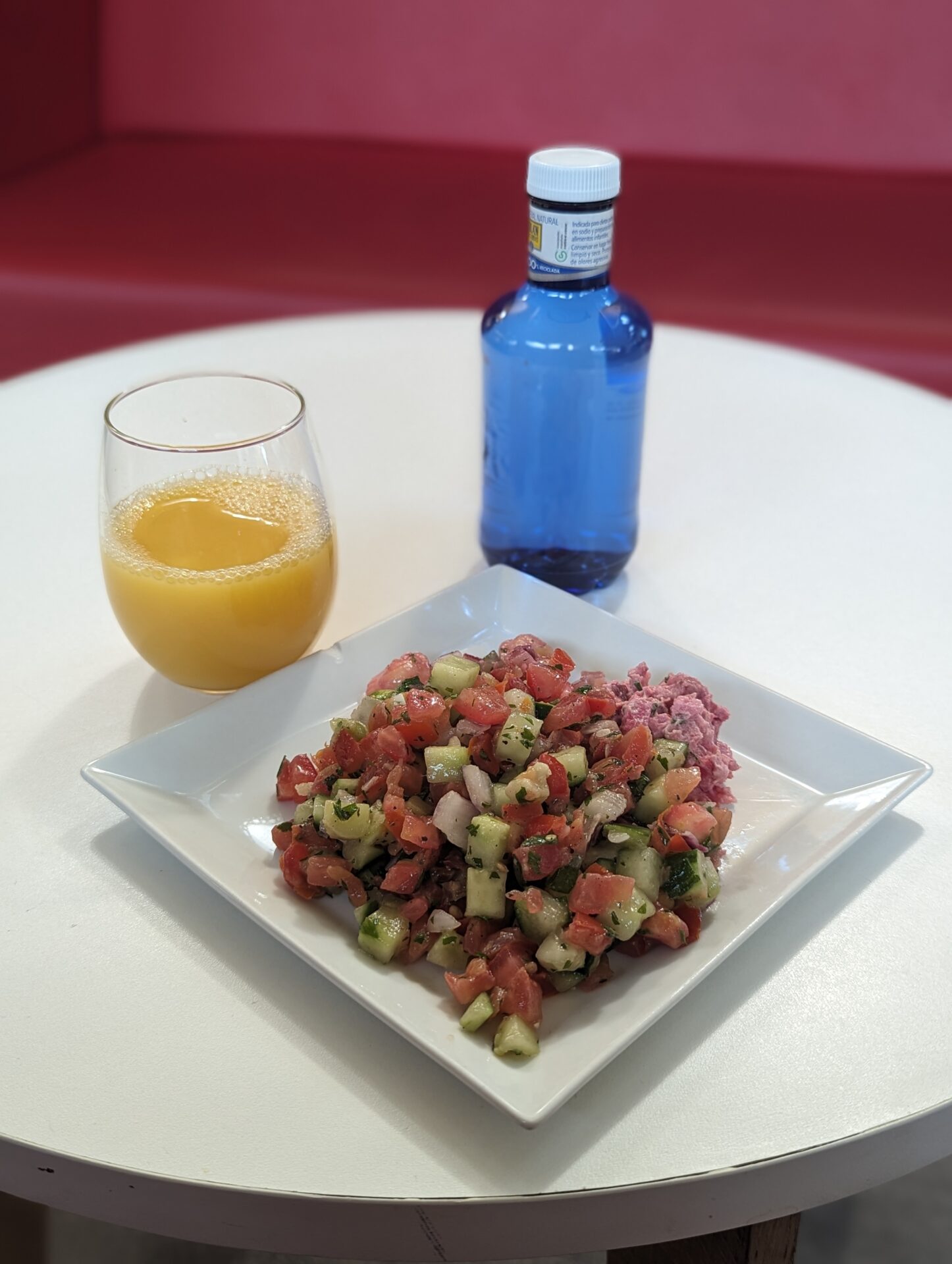 a plate of salad and a glass of juice