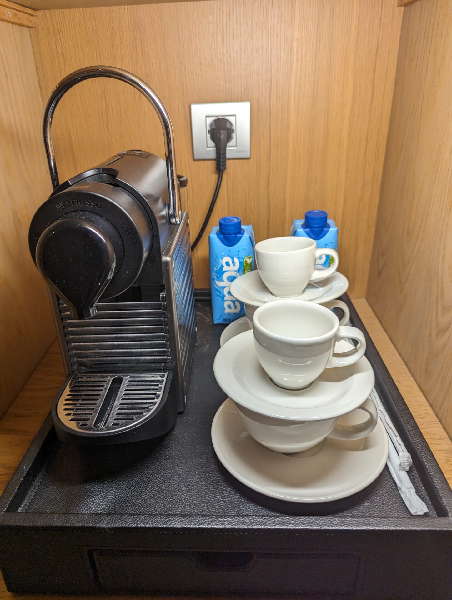 a coffee machine and cups on a tray