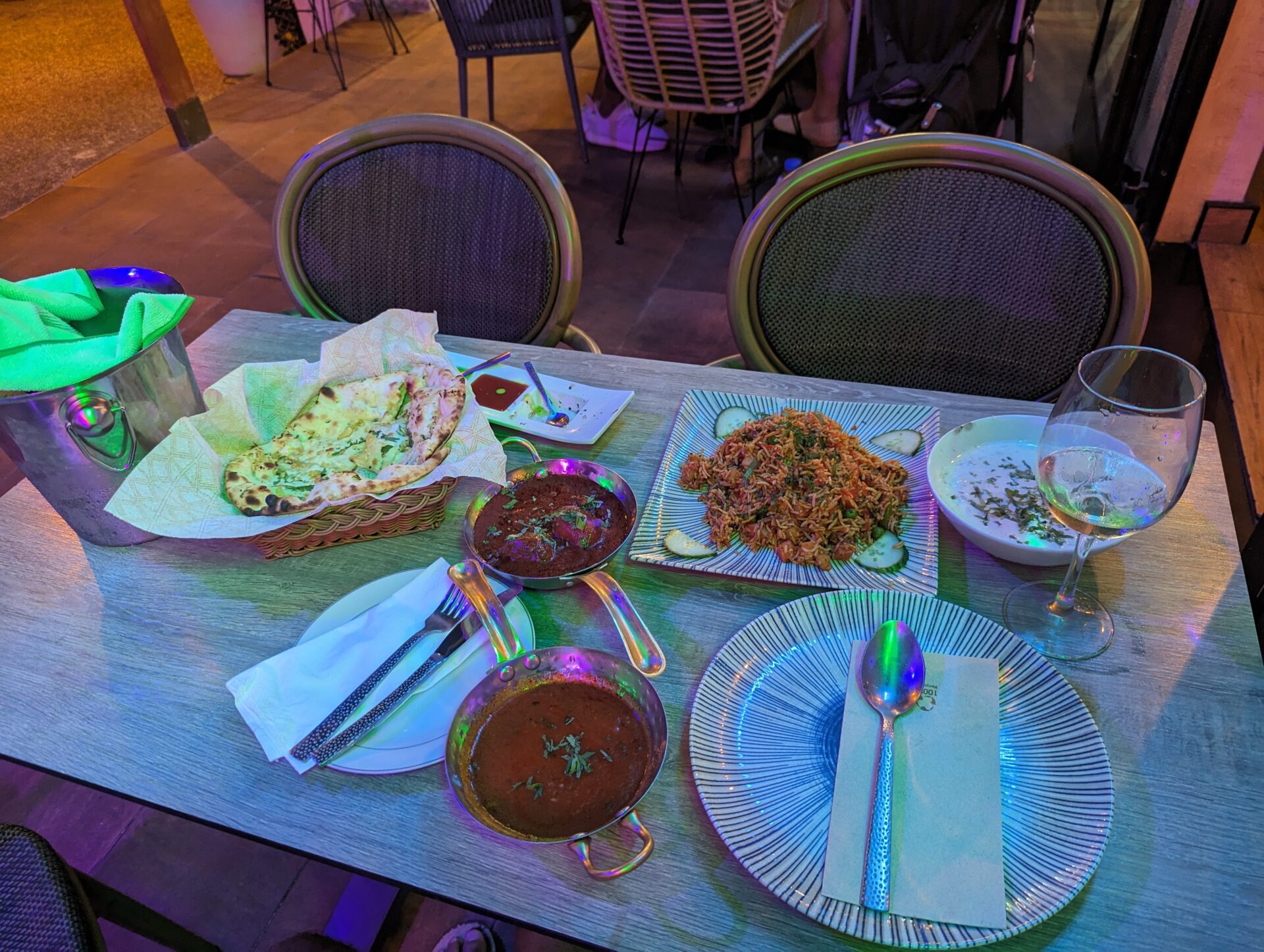a table with plates of food and glasses of wine