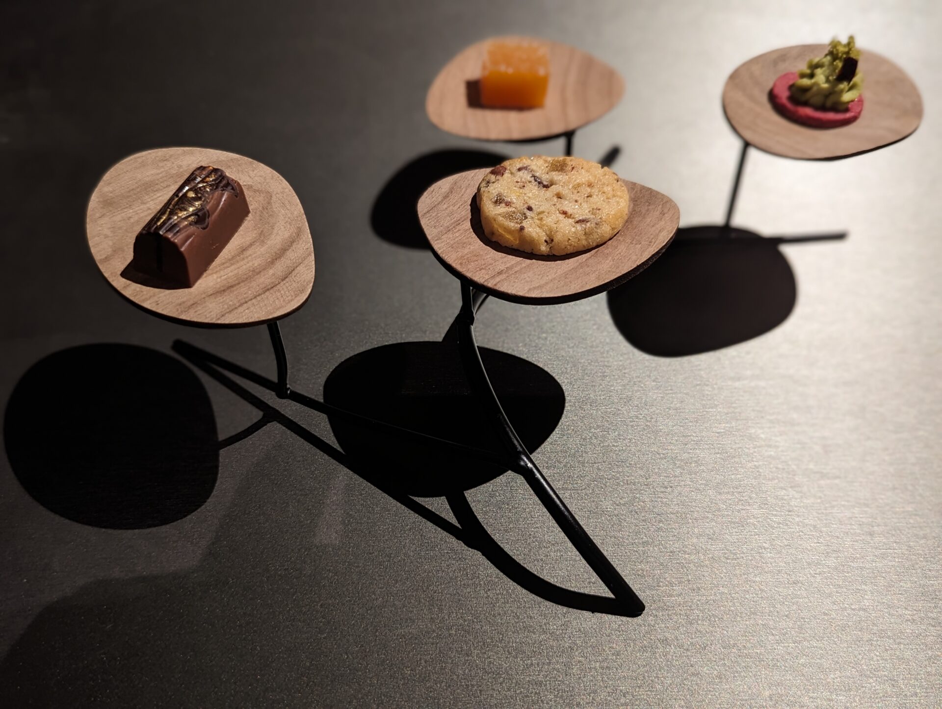 a small wooden objects with different foods on them