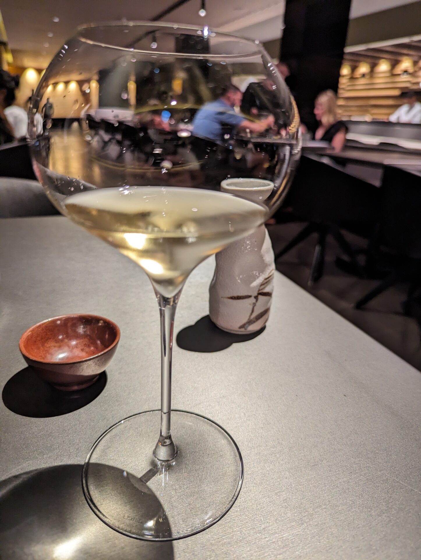 a glass of white wine on a table