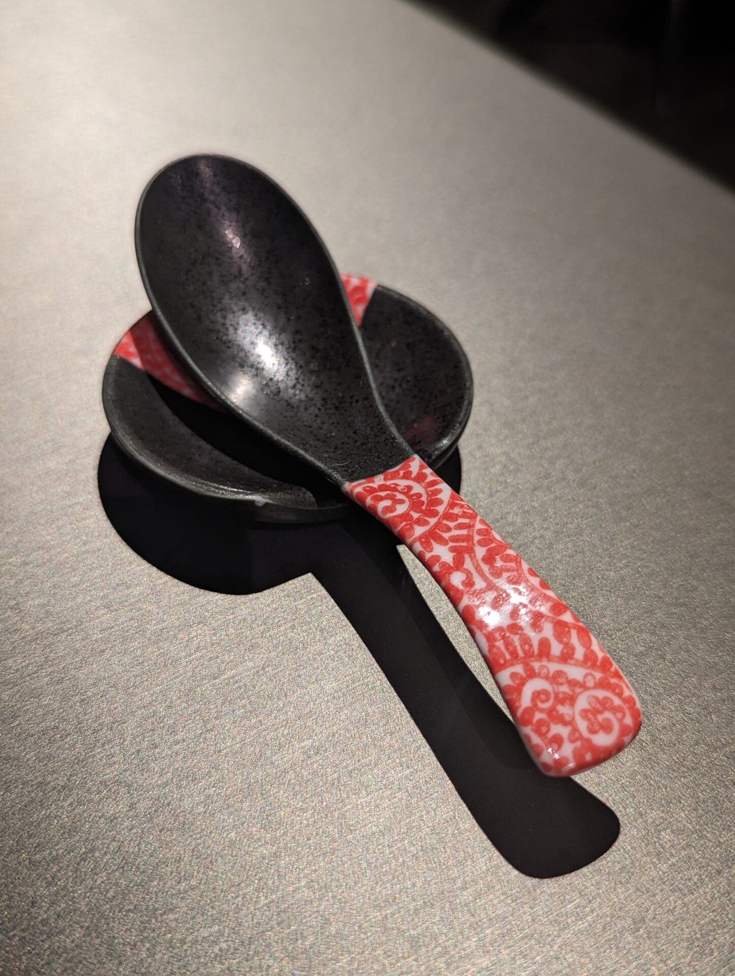 a spoon and bowl on a table