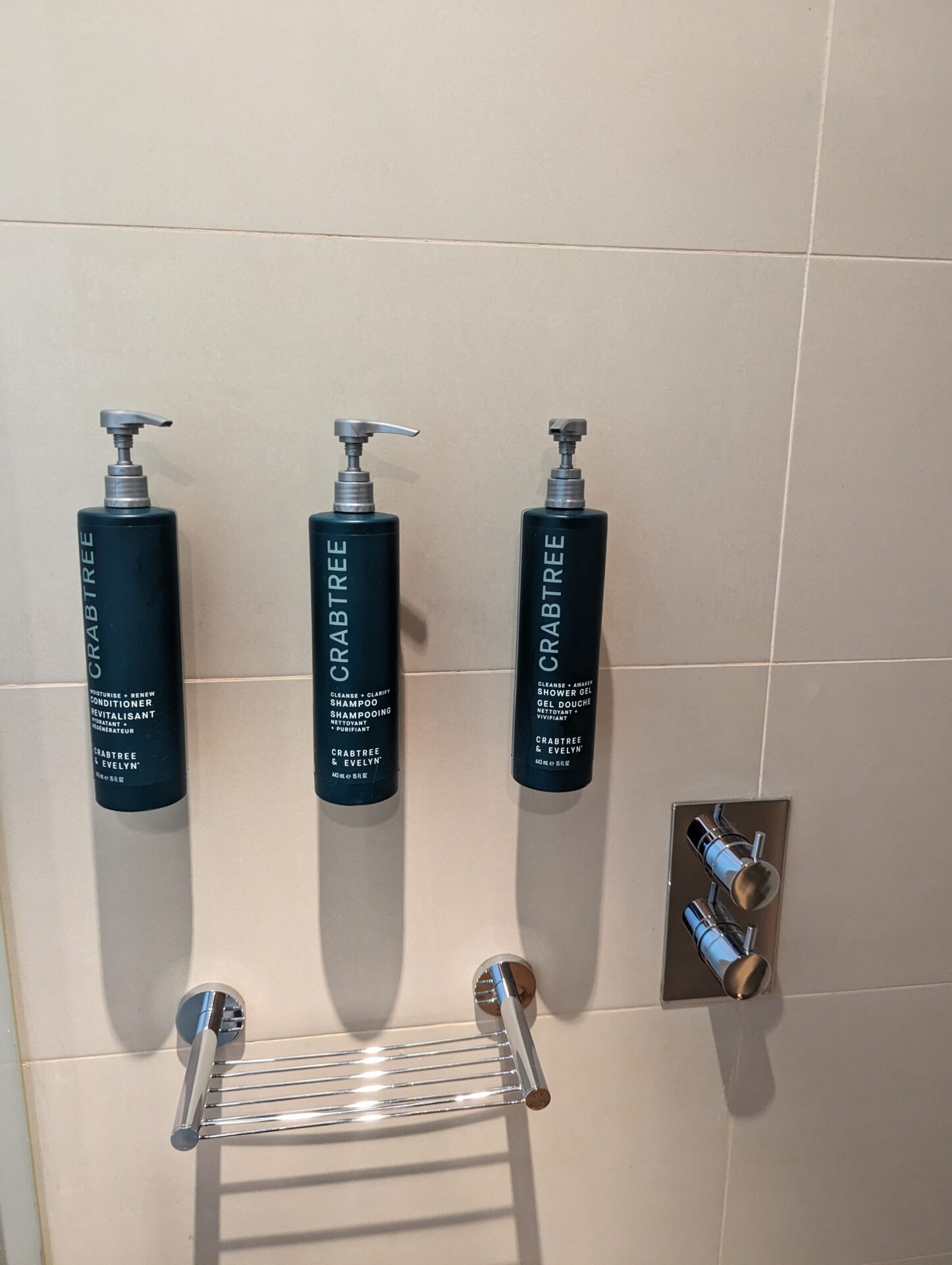 a group of soap dispensers on a wall