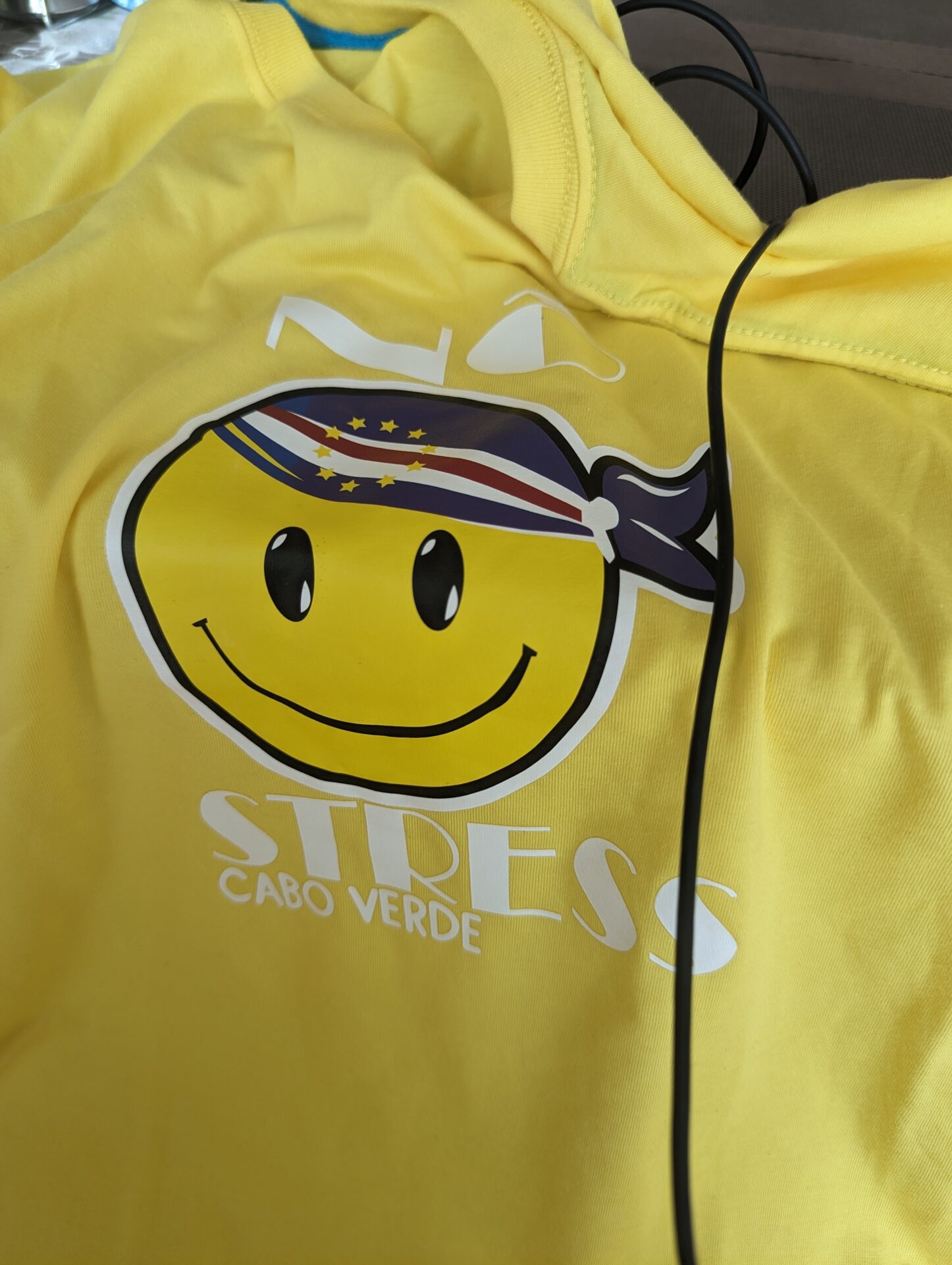 a yellow shirt with a smiley face on it