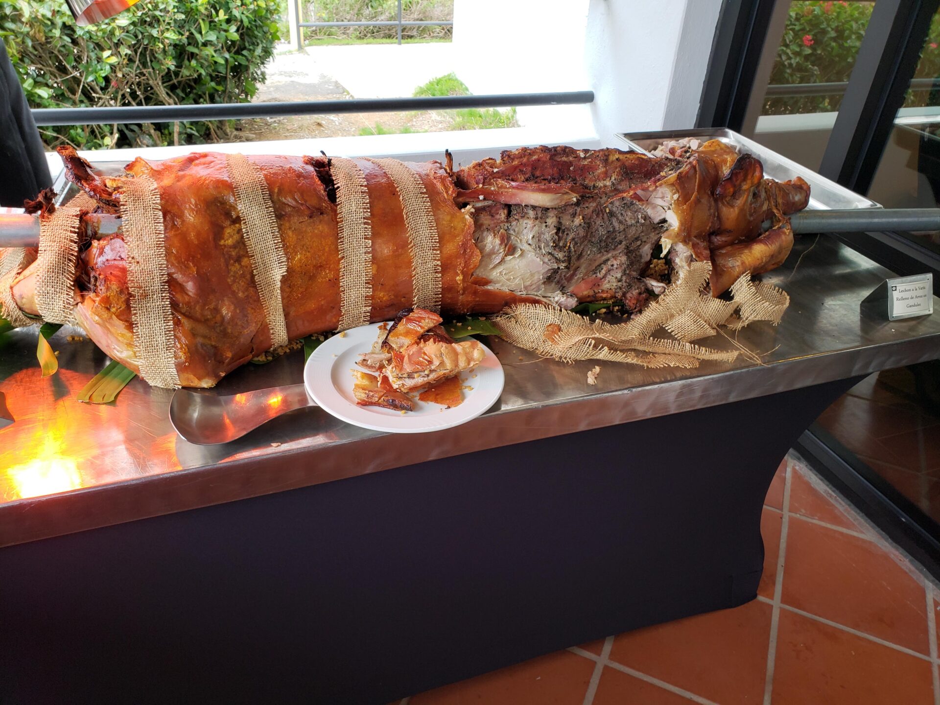 a large cooked pig on a metal table