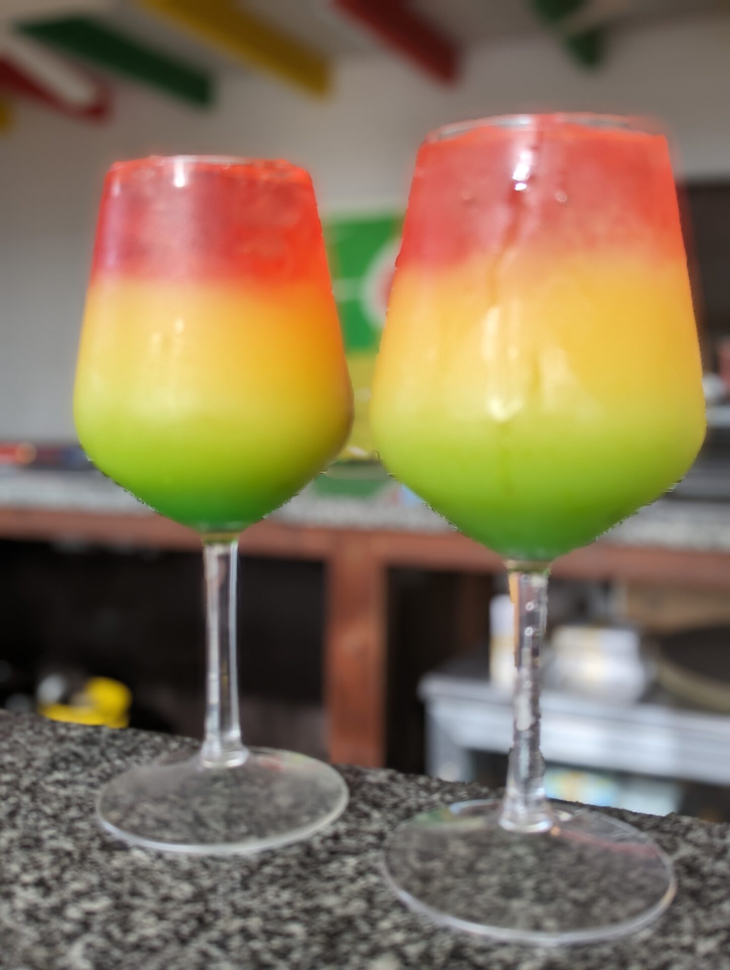 two glasses of colorful drinks