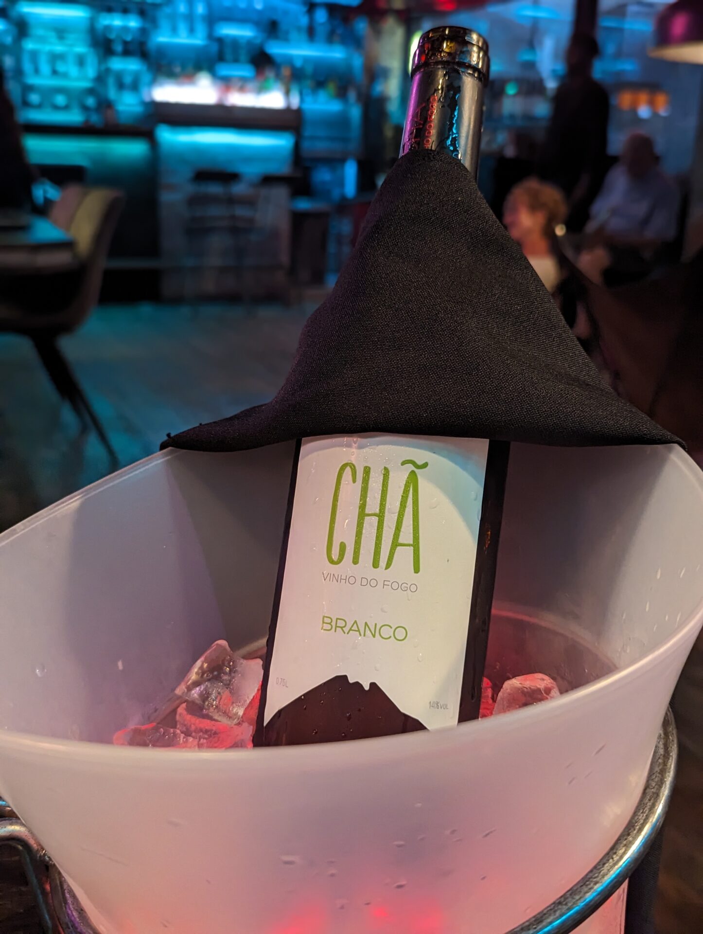 a bottle of wine in a bucket with ice