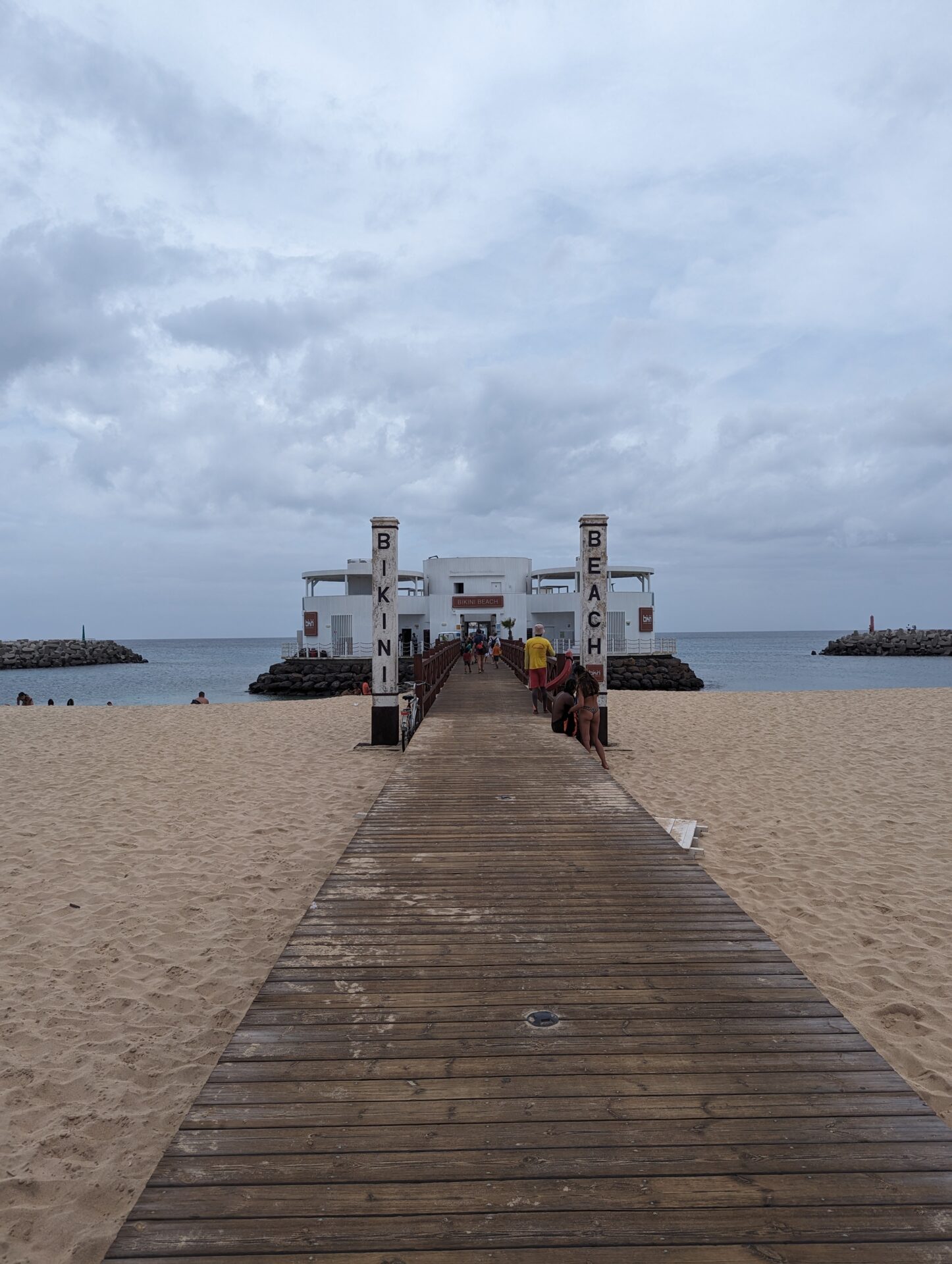 a wooden walkway leading to a beach