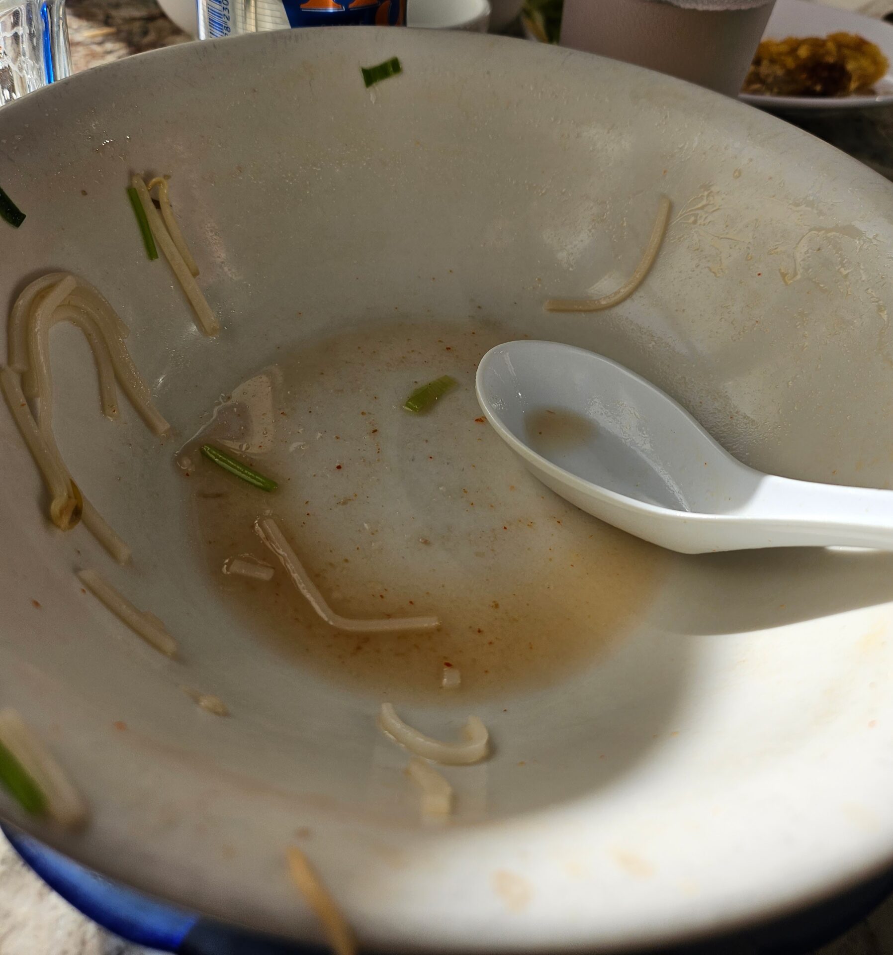 a bowl with noodles and a spoon