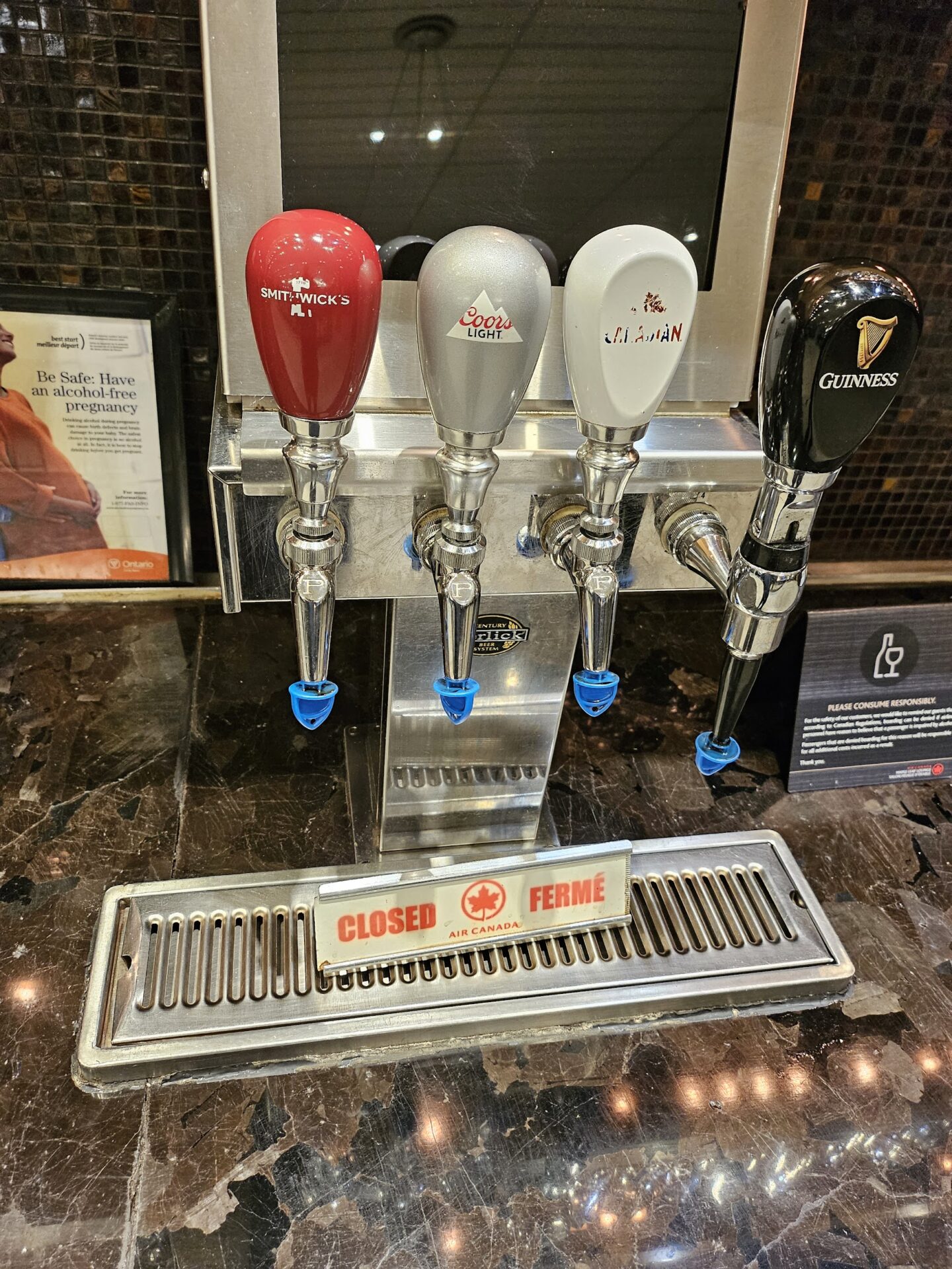 a row of beer taps on a counter
