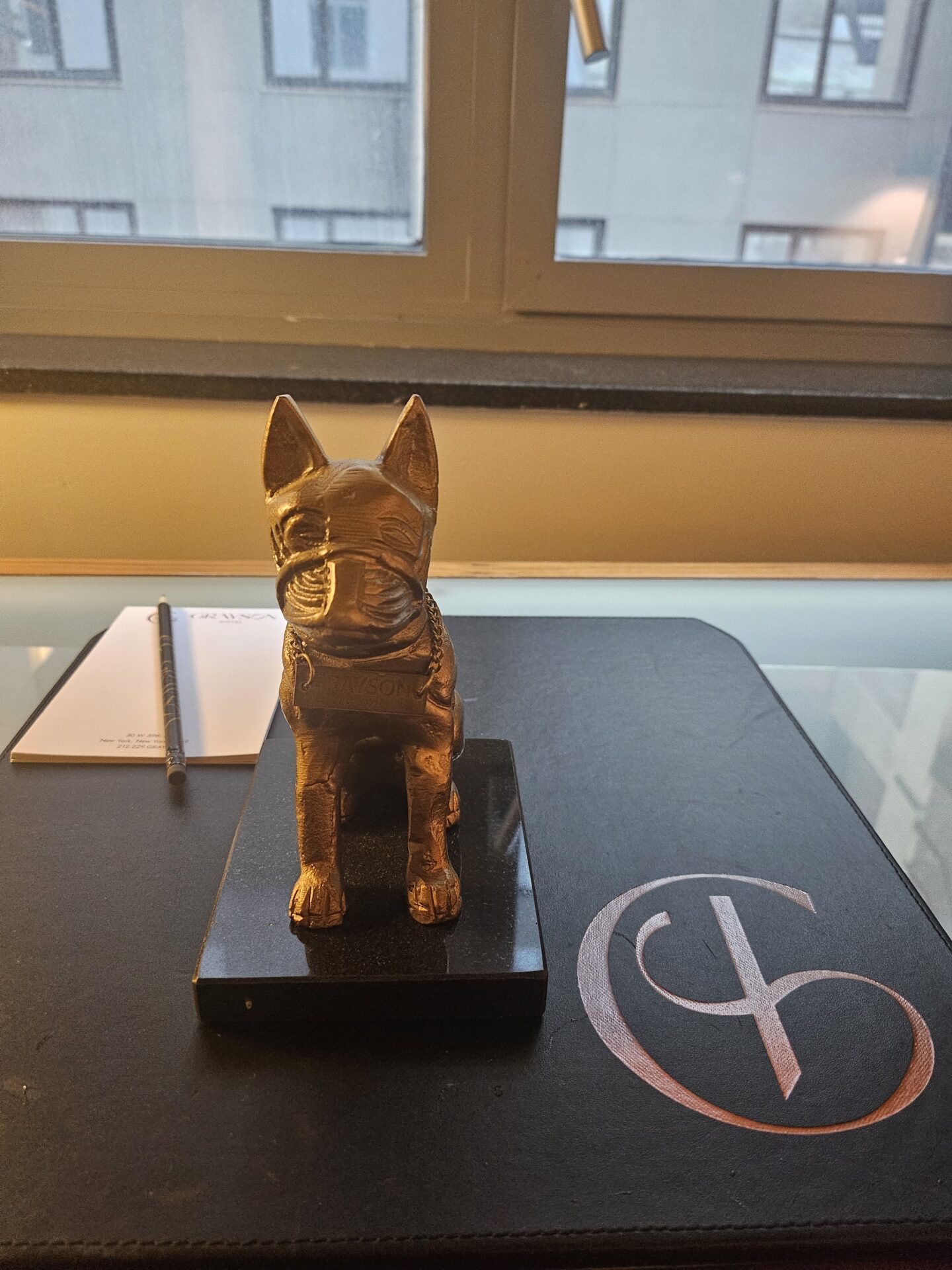 a statue of a dog on a desk