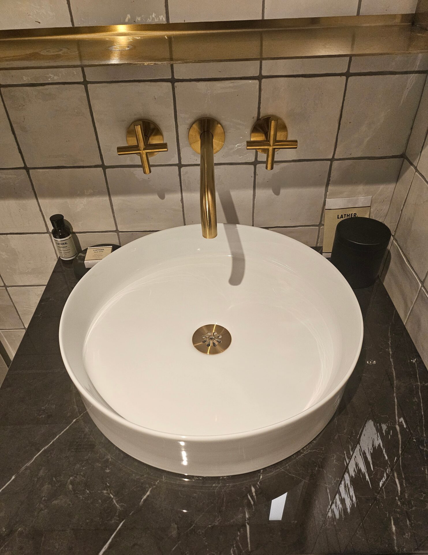 a sink with gold faucet