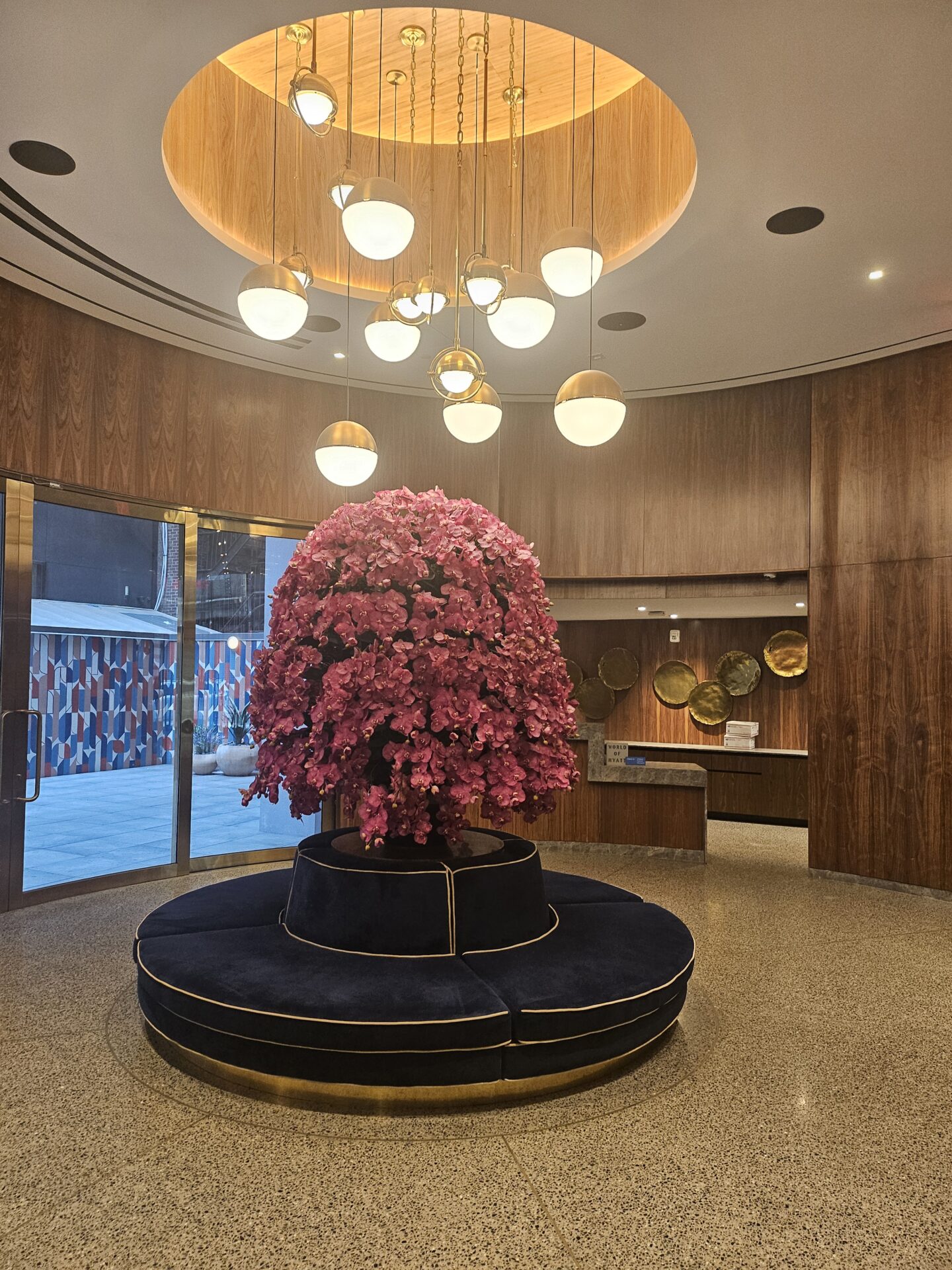 a tree with pink flowers in a lobby
