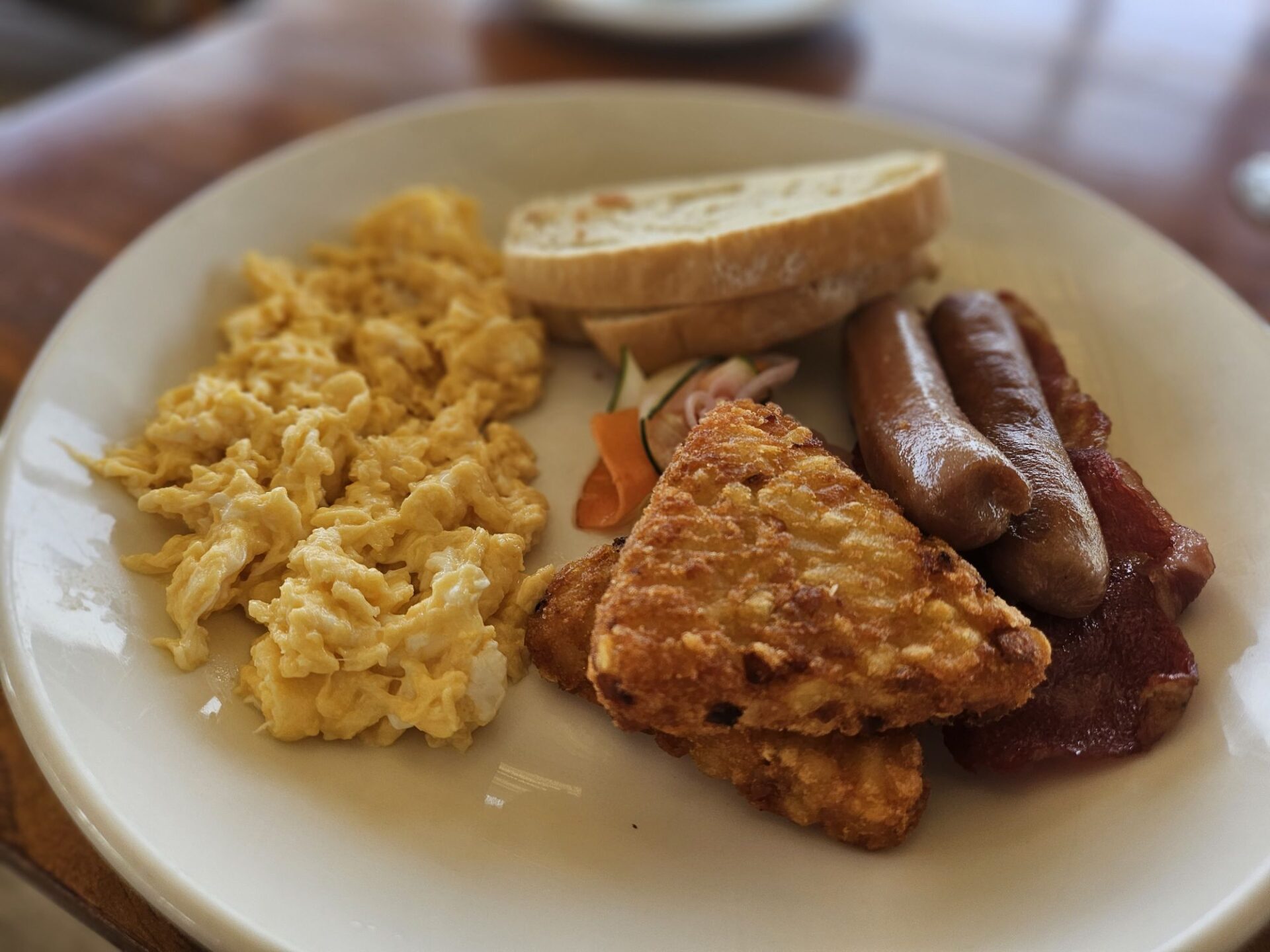 a plate of breakfast with sausages and eggs