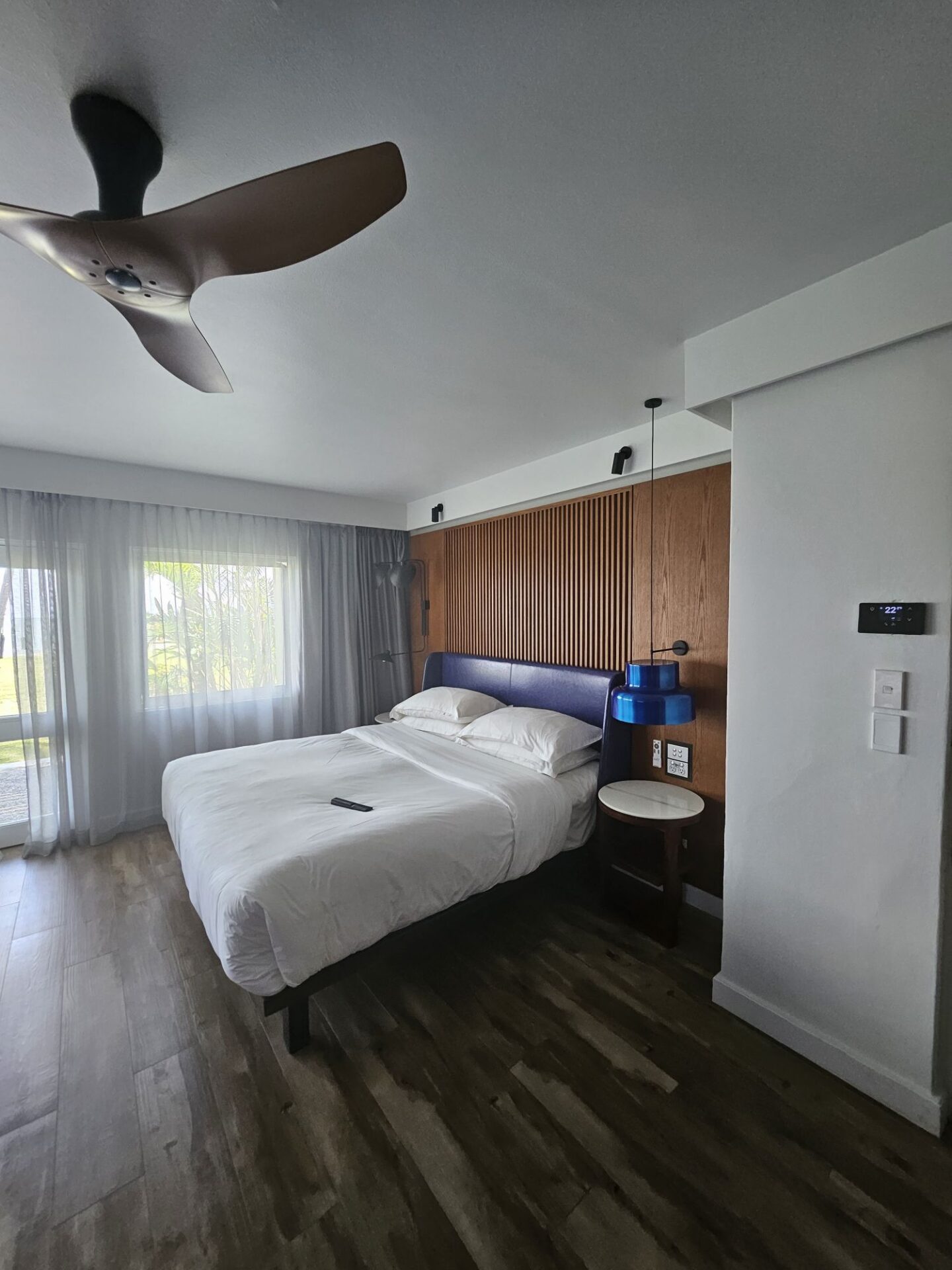 a bed with a fan in a room