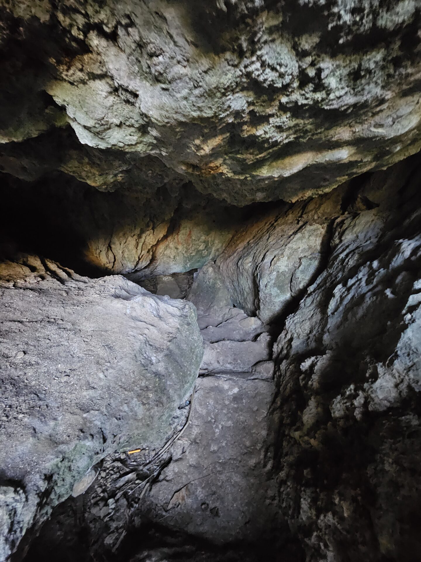 a cave with rocks and a path