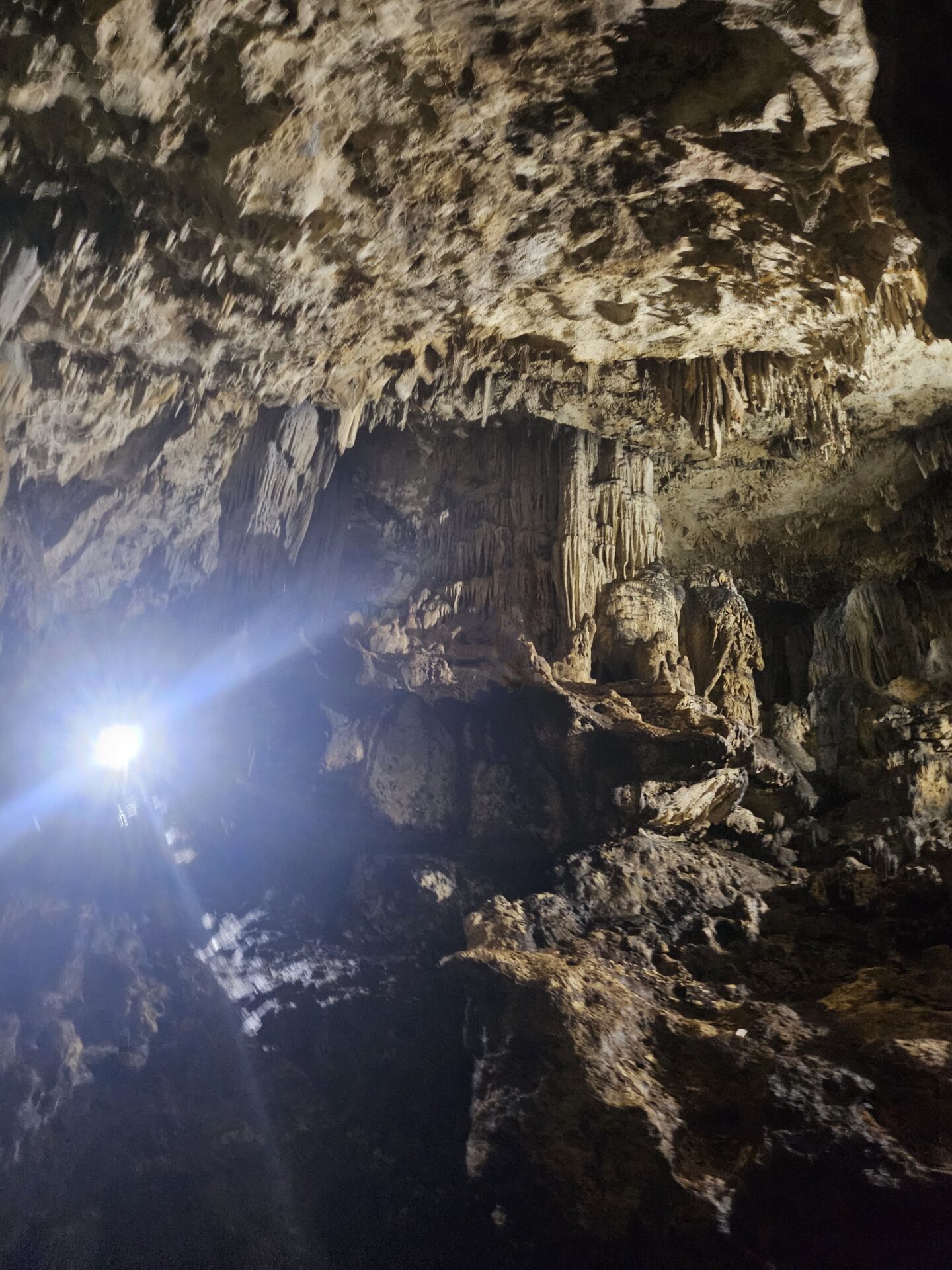 a light shining through a cave