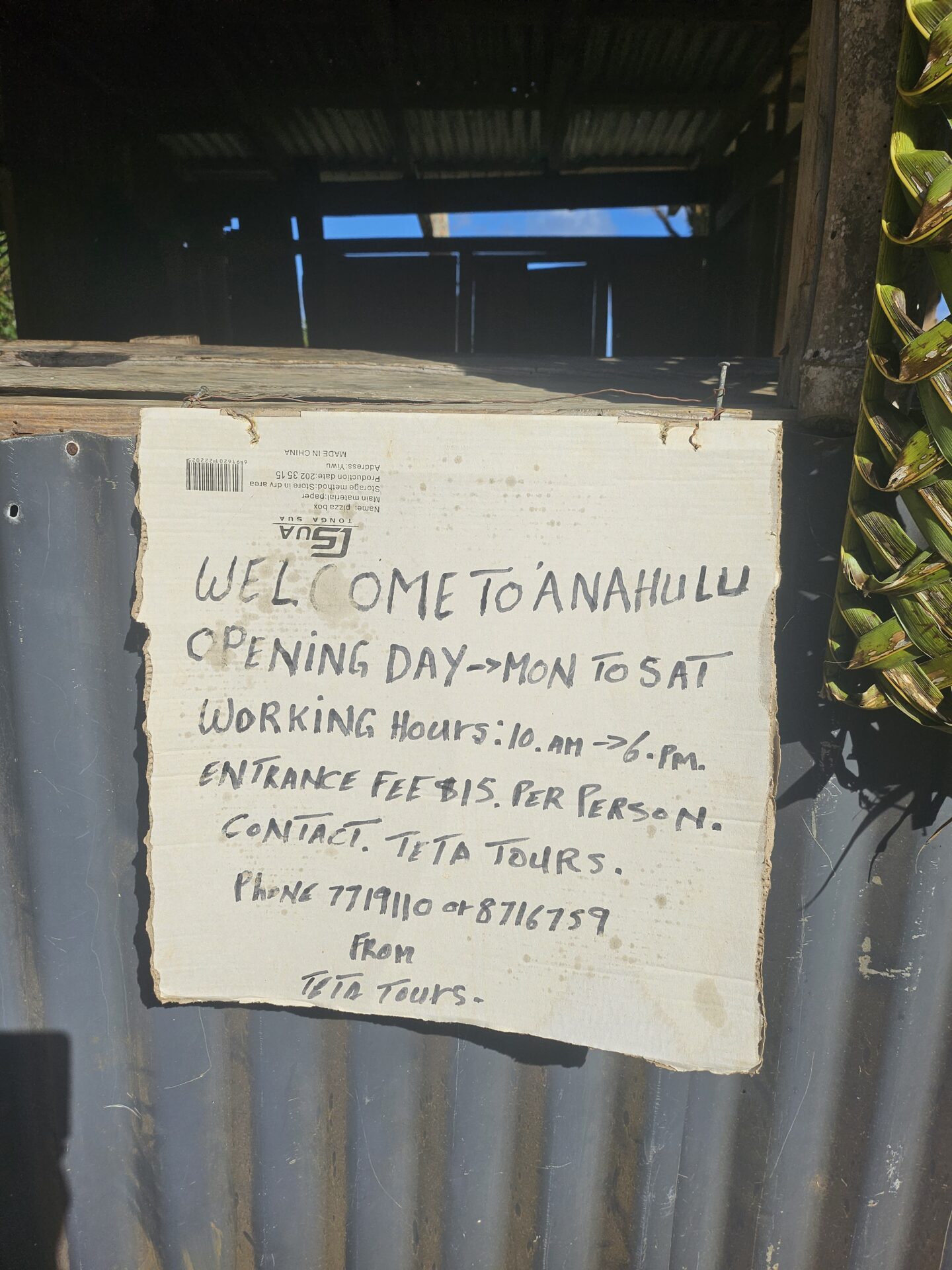 a sign on a corrugated metal wall