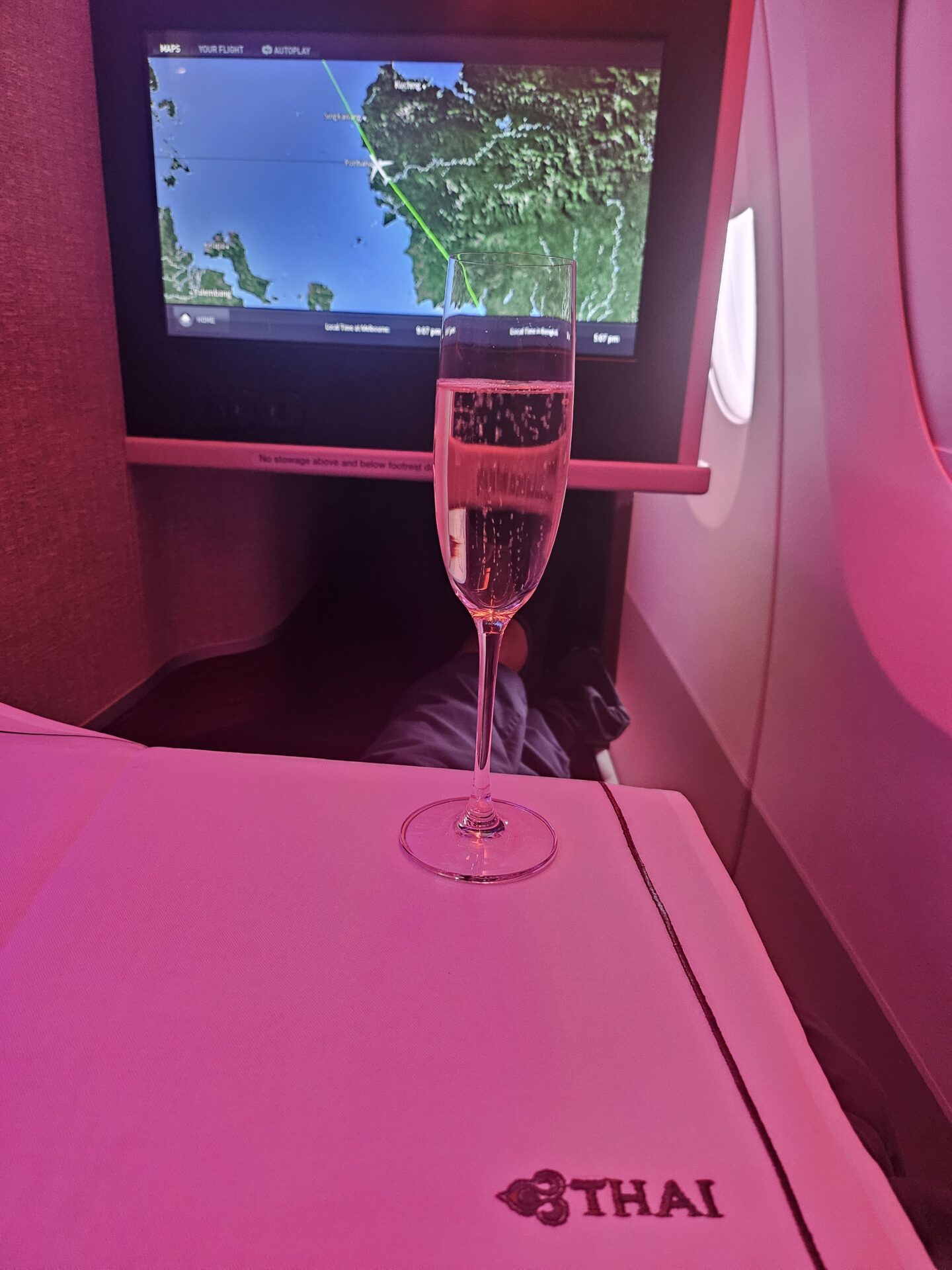 a glass of champagne on a table in a plane