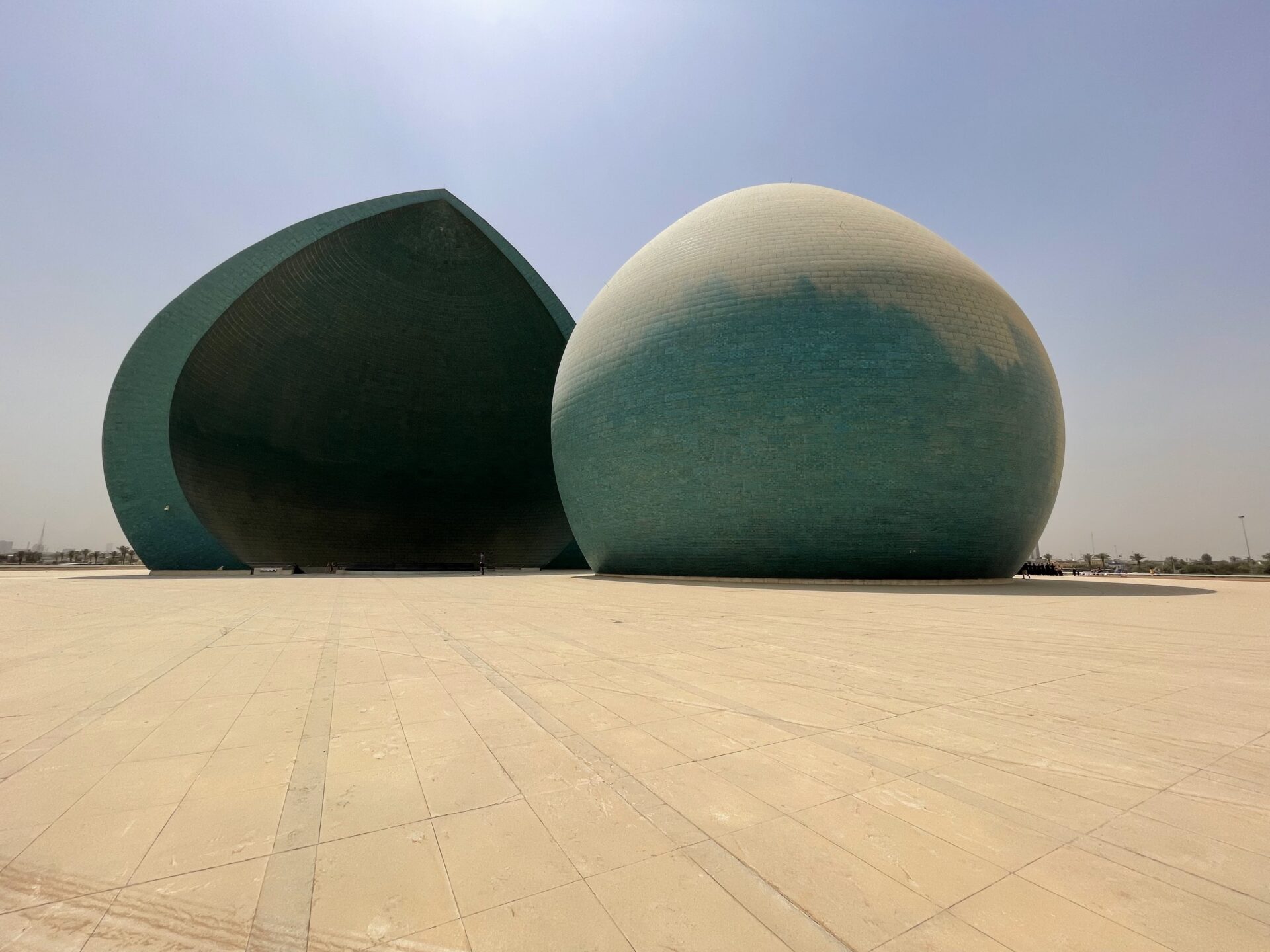 two large round buildings in a desert