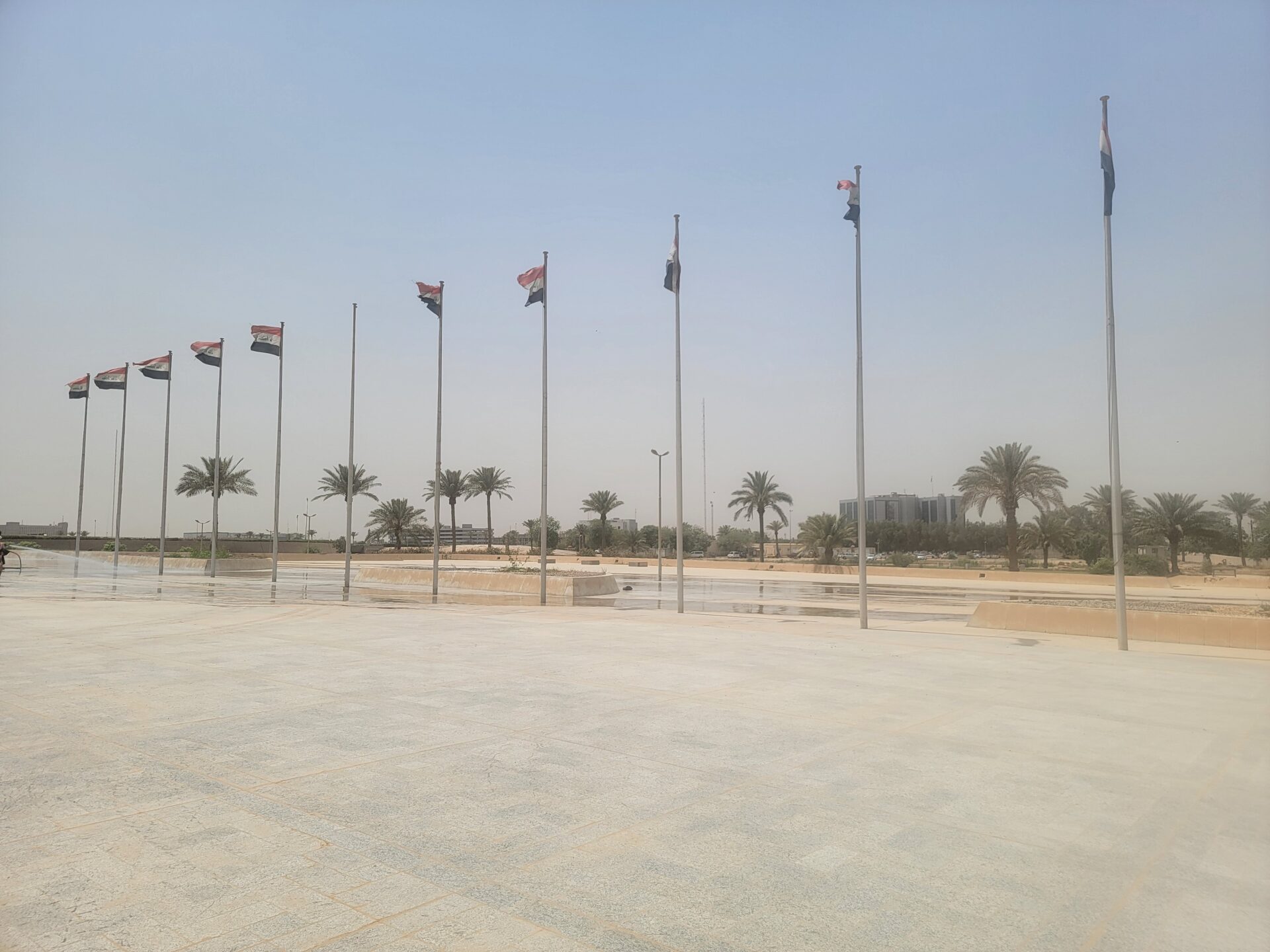 a group of flags on poles