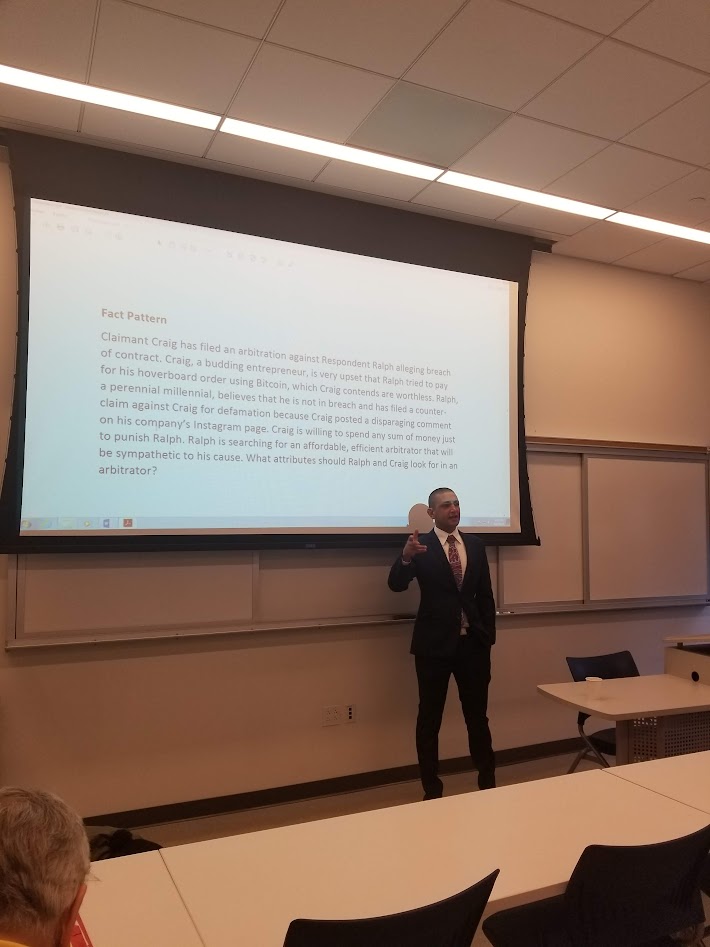 a man in a suit giving a presentation