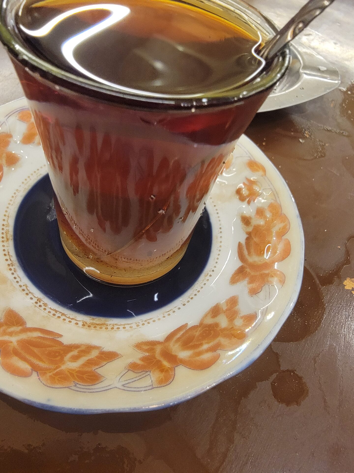 a cup of liquid on a plate