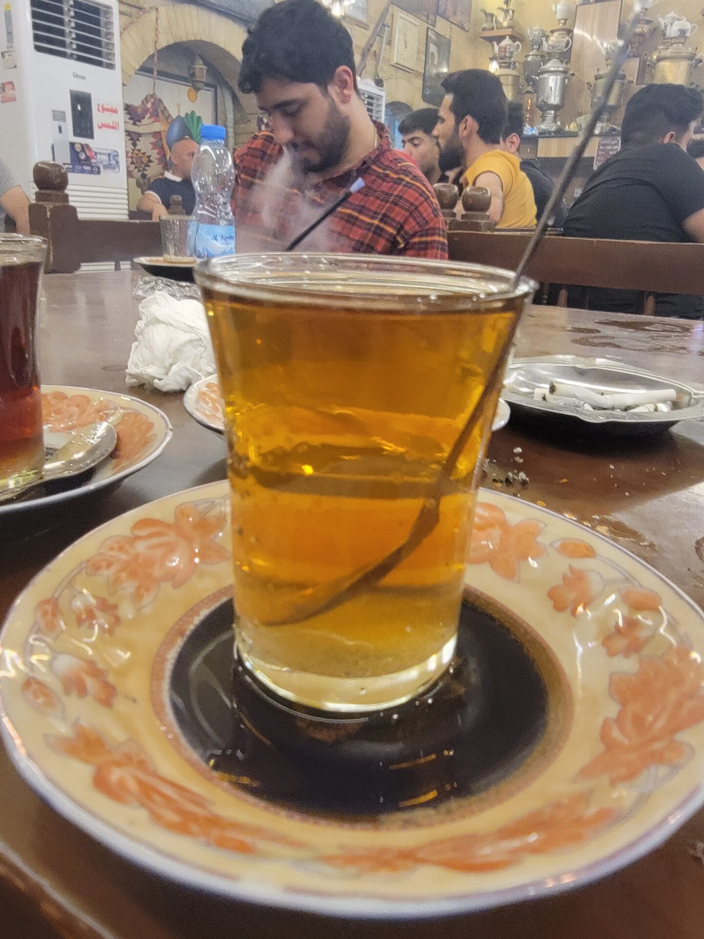 a glass of liquid on a plate