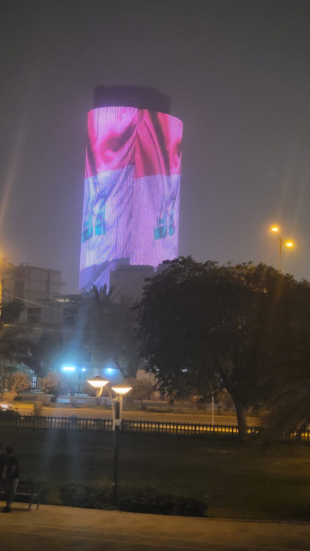 a tall building with a large flag on it