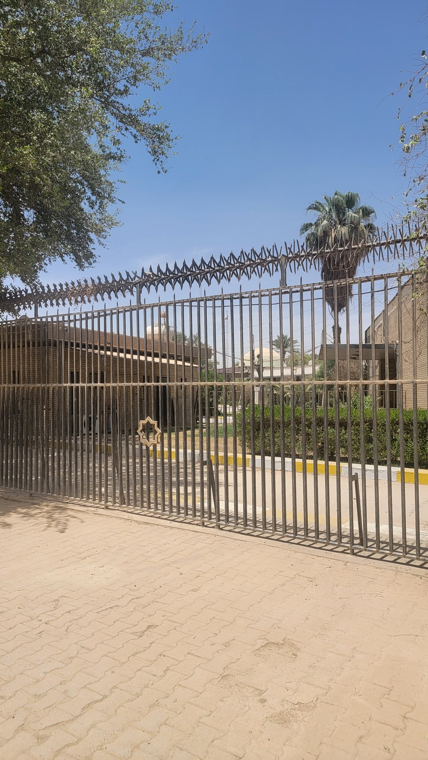 a gate with a building behind it