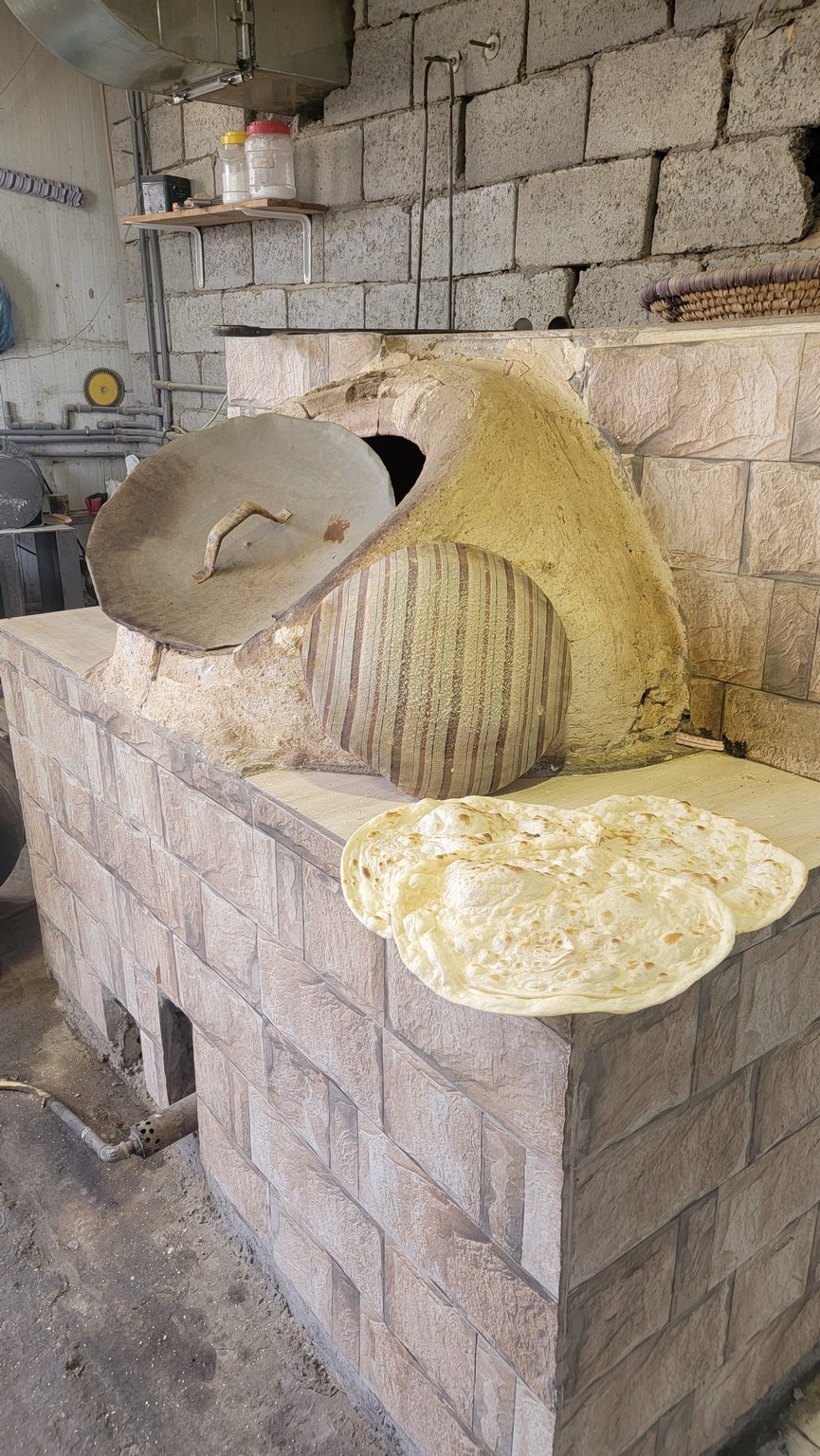 a stone oven with a round oven and round pans