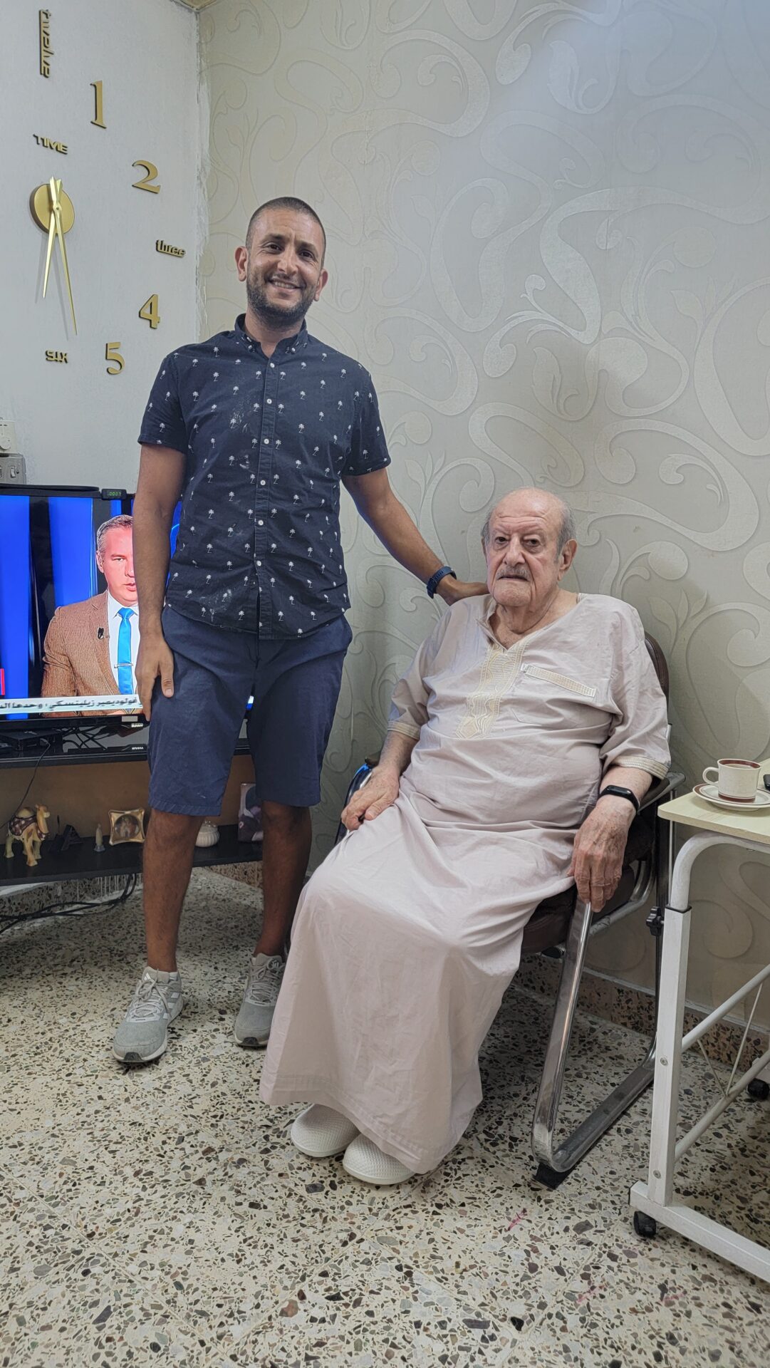 a man standing next to an old man