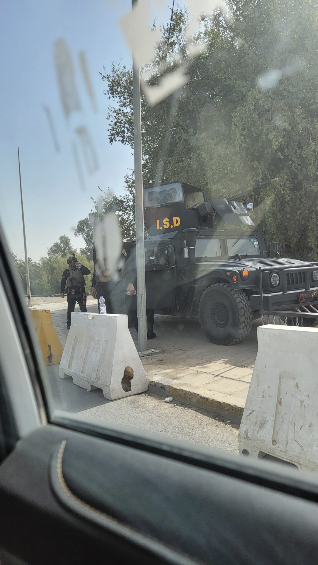 a military vehicle with a gun in front of a window