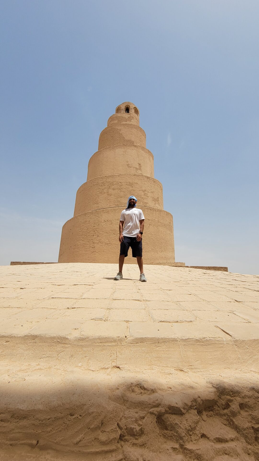 a man standing in front of a large tower
