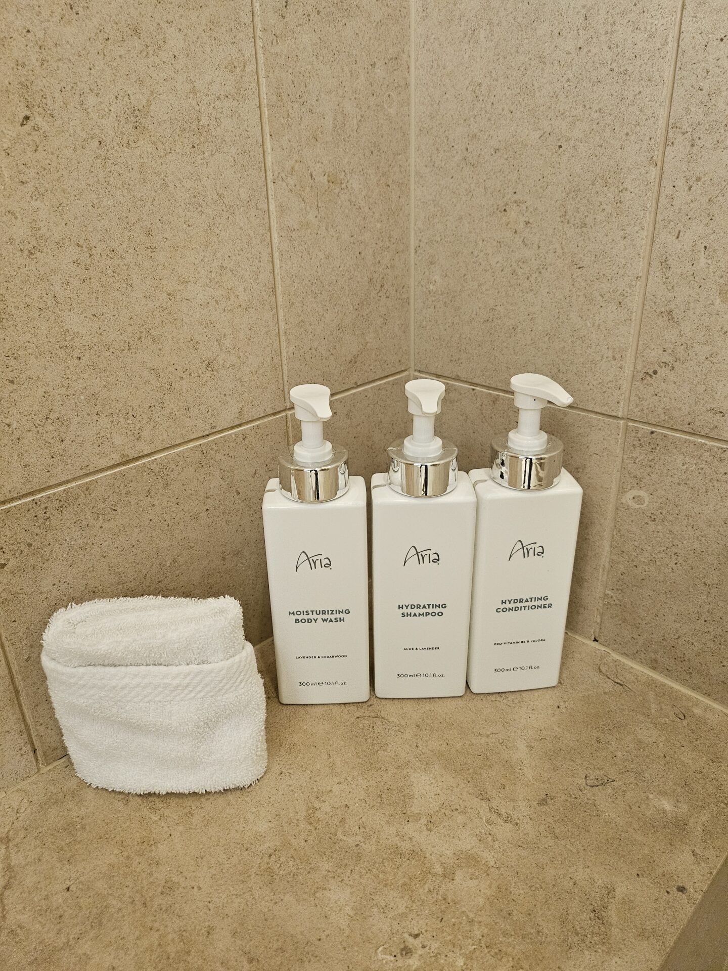 a group of white bottles next to a towel