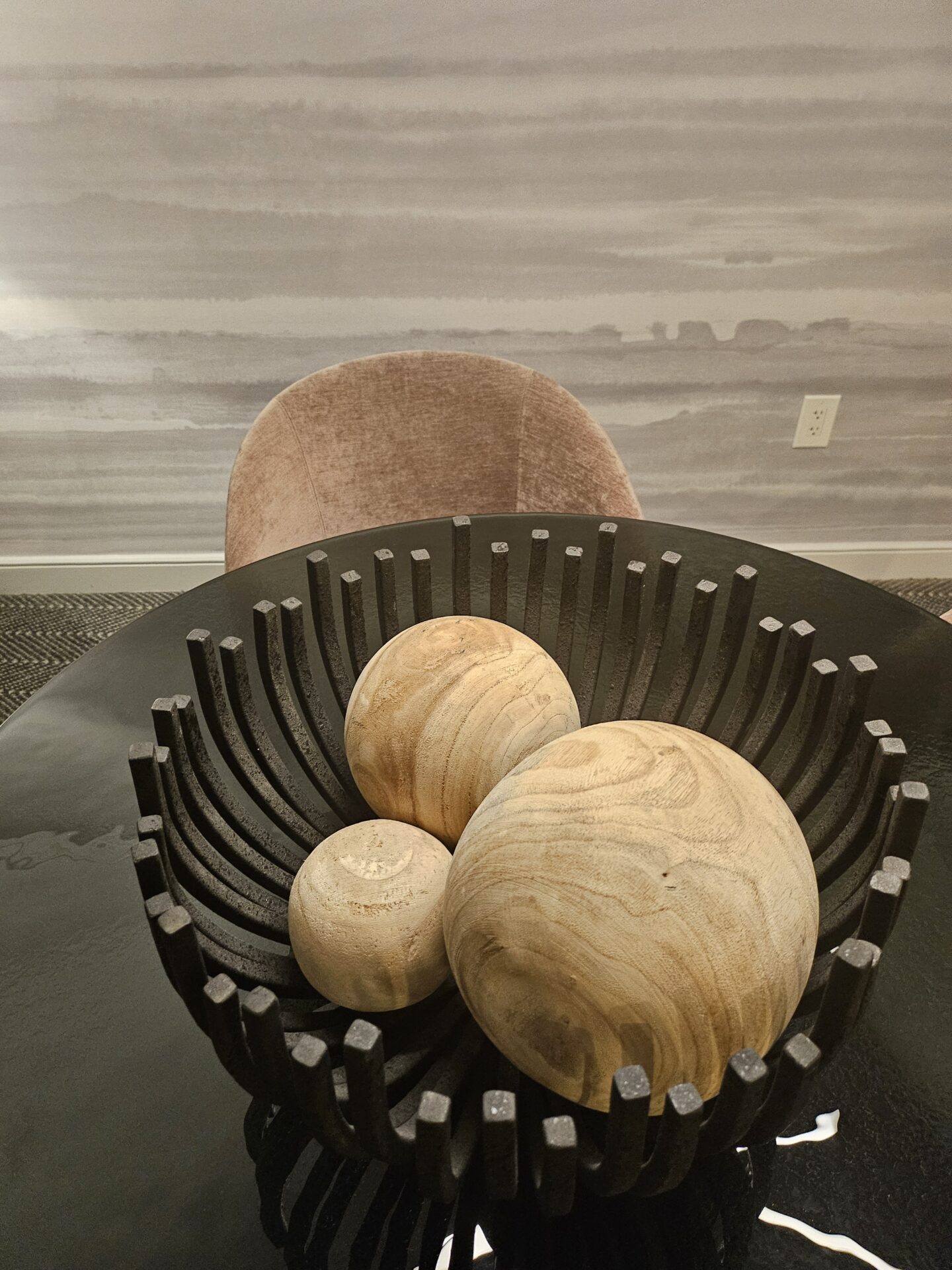 a group of wood balls on a black table