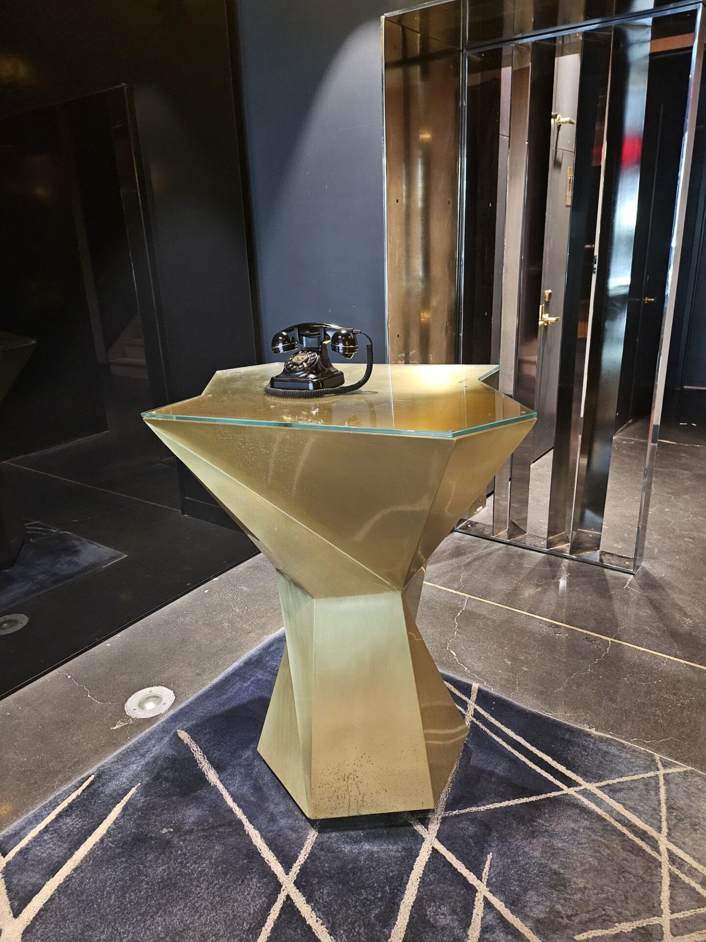 a gold pedestal with a telephone on it