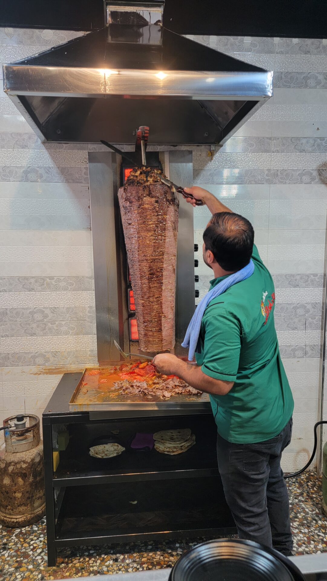 a man cutting a large meat on a large machine